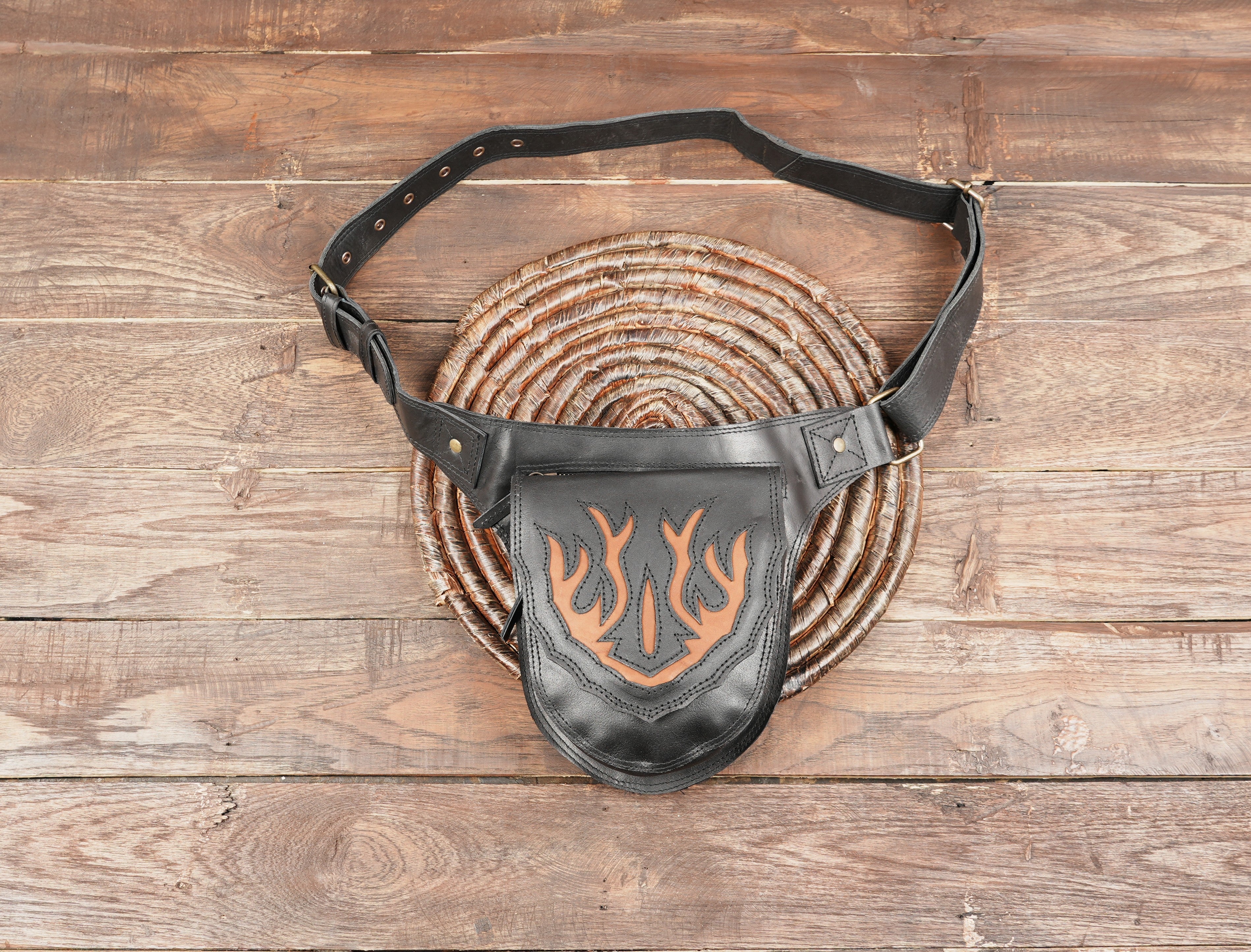Black leather waist belt bag with brown flame pattern on the flap