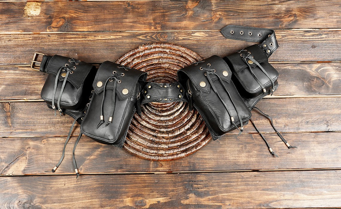 black leather waist bag with brass accents and adjustable strap 