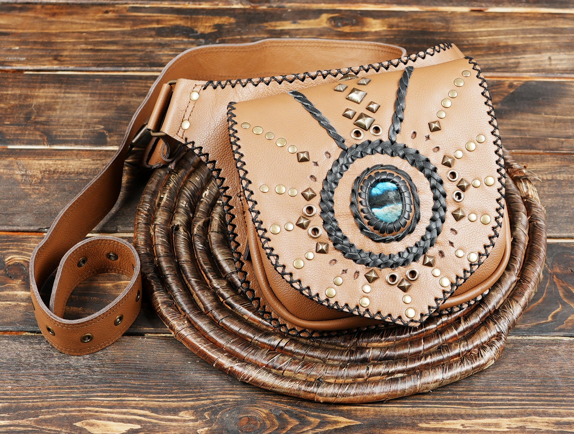 Tan leather crossbody belt bag with gemstone and handwoven black braid