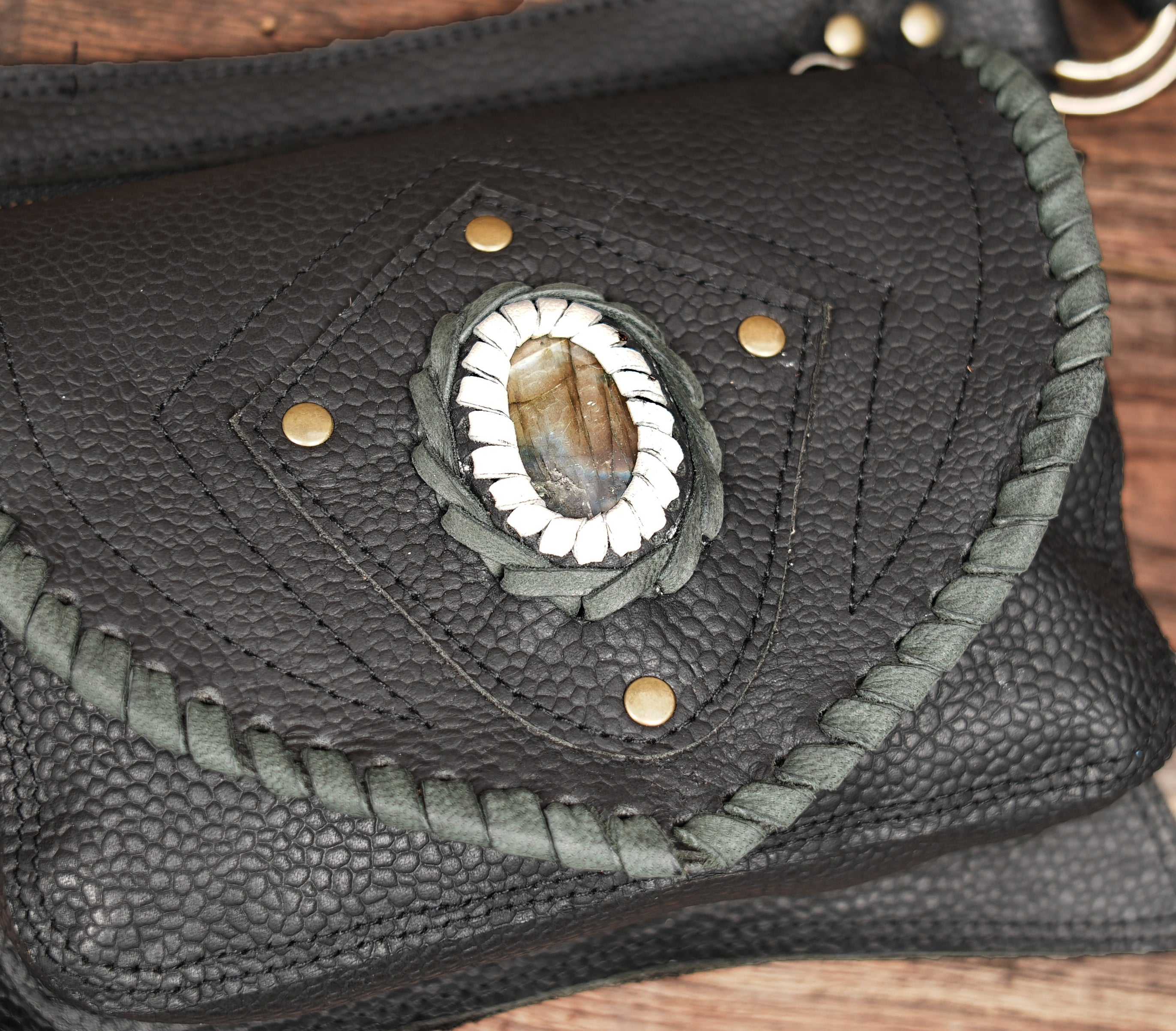 Back view of black leather gemstone hip pouch with zipper compartment
