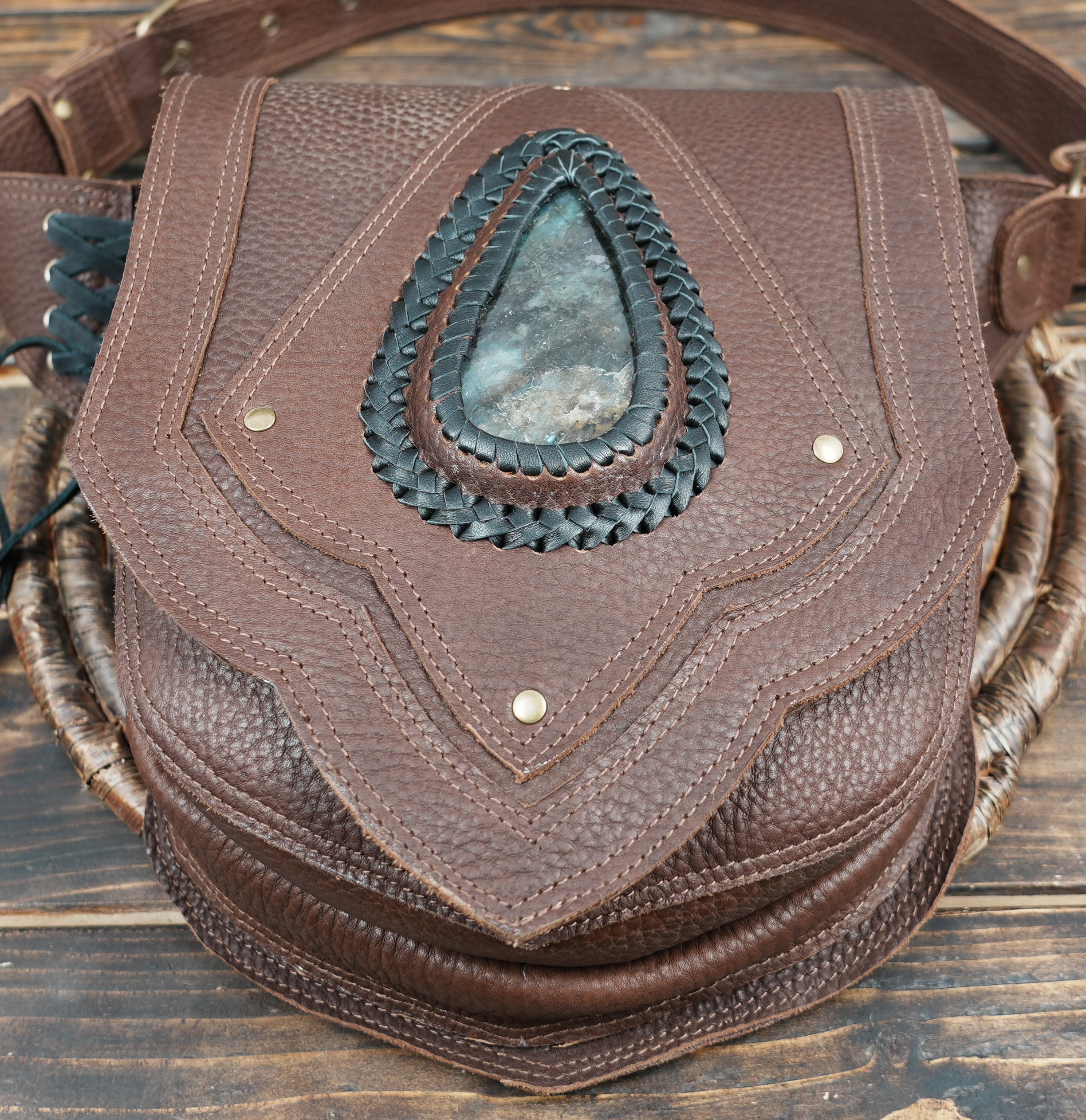 Luxury handcrafted leather hip bag with teardrop stone and unique stitching