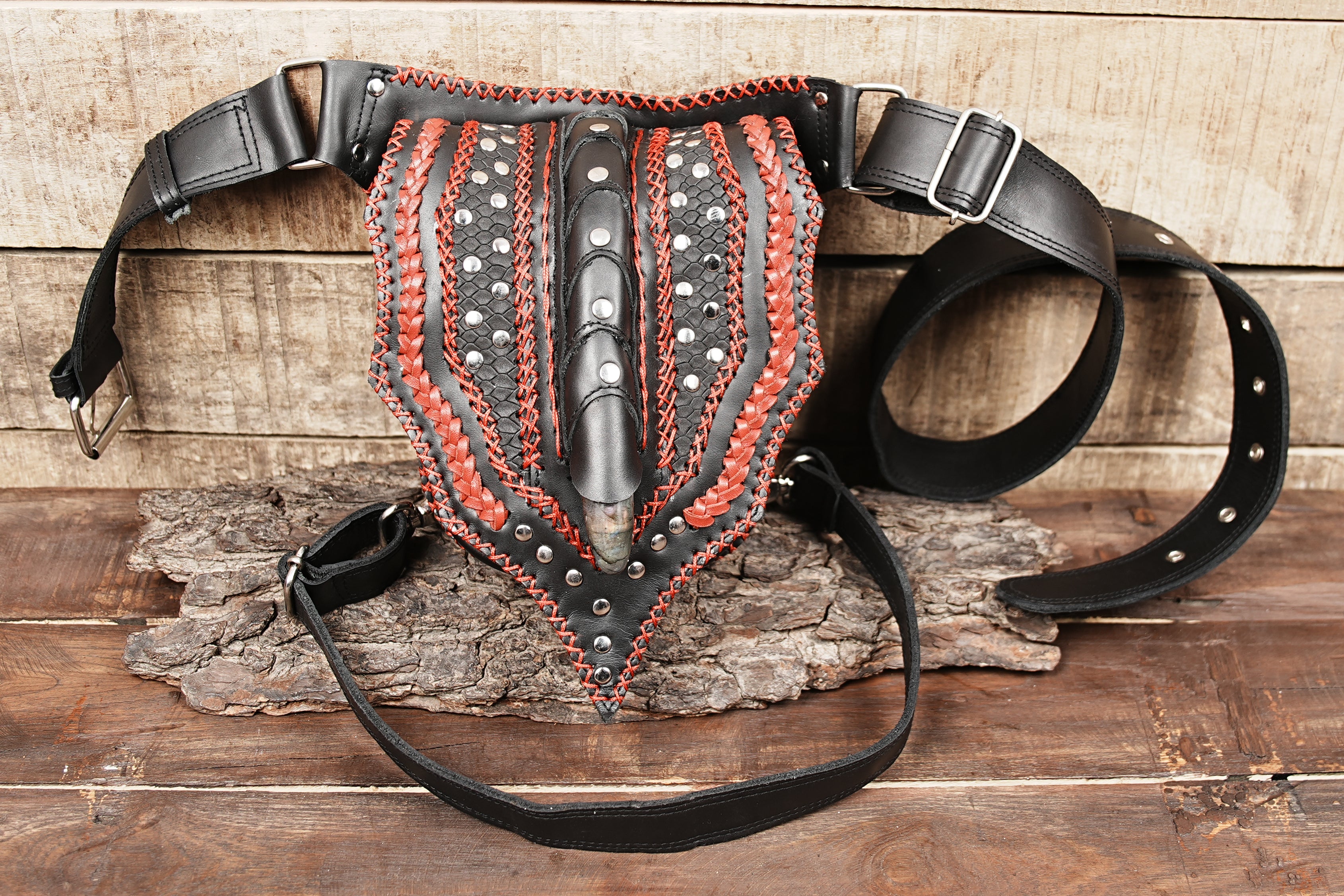 Rock-style leather hip bag with red braiding and metallic hardware