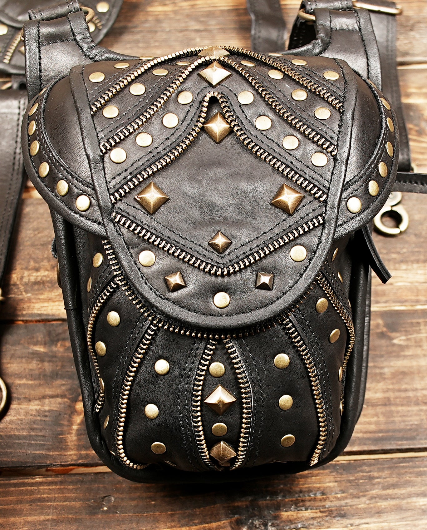 Black leather steampunk holster harness with metal accents