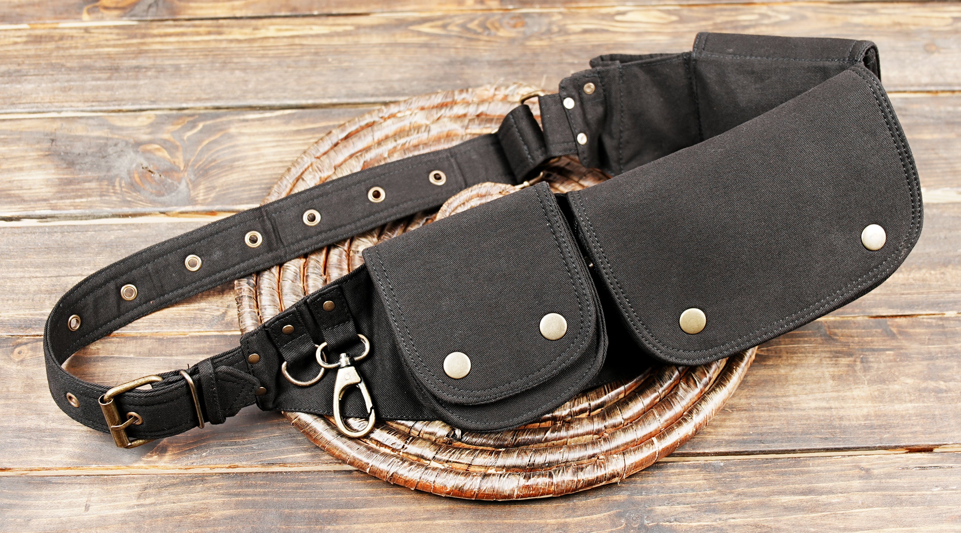 Black canvas utility belt bag with three pockets and snap closures
