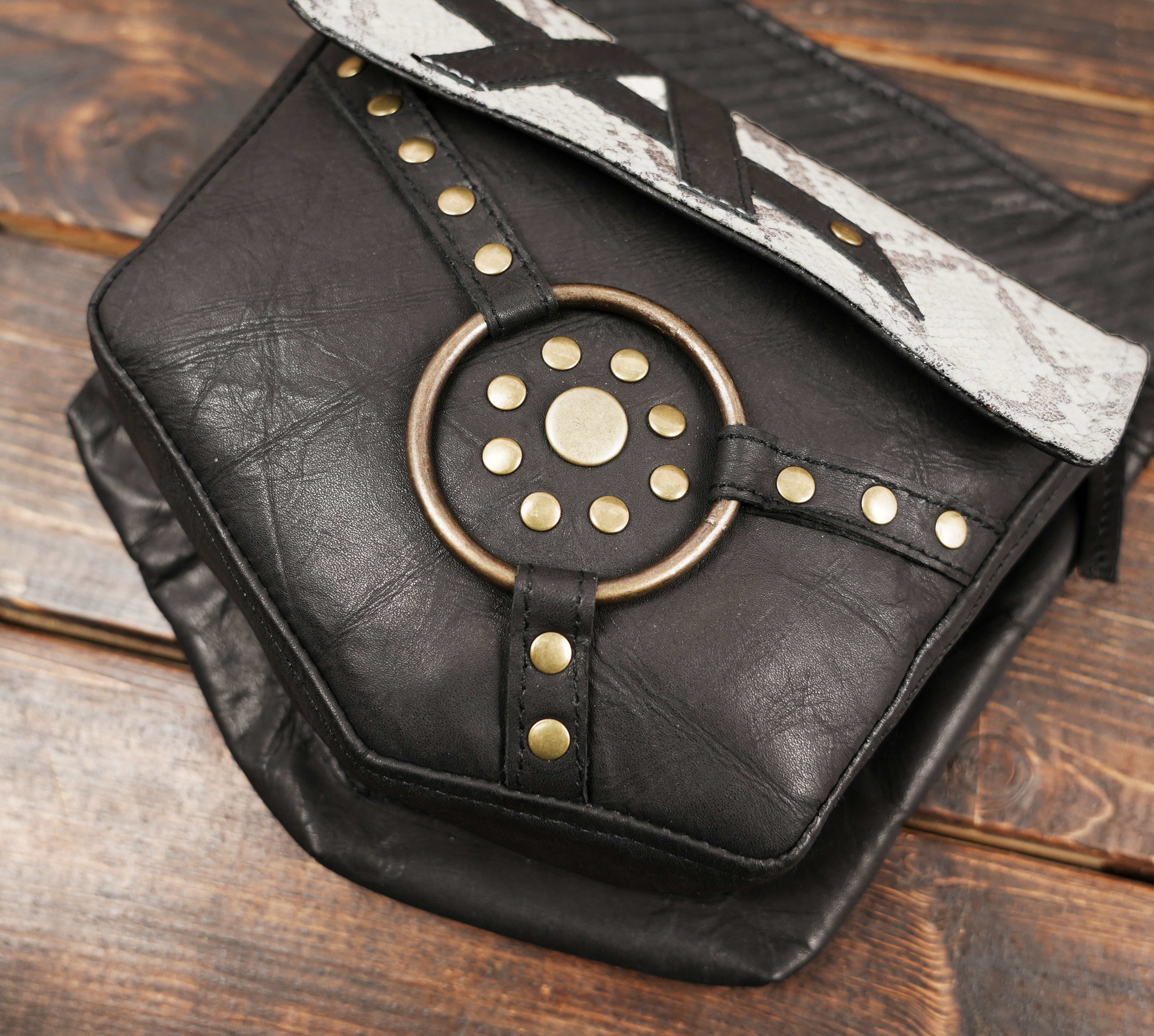 Gothic festival holster bag with brass ring centerpiece and bold pattern.