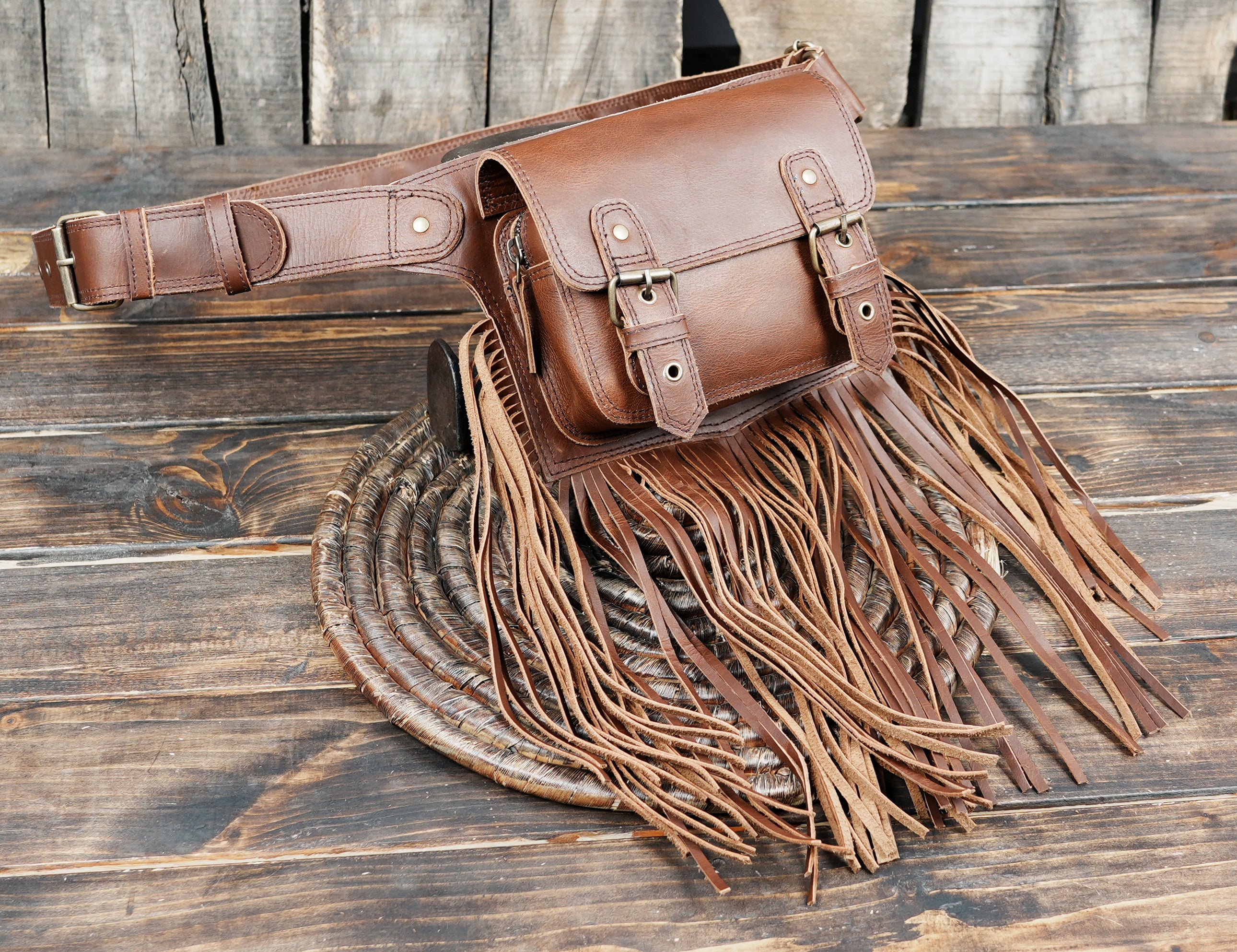 Adjustable brown leather fringe belt bag for events and travel