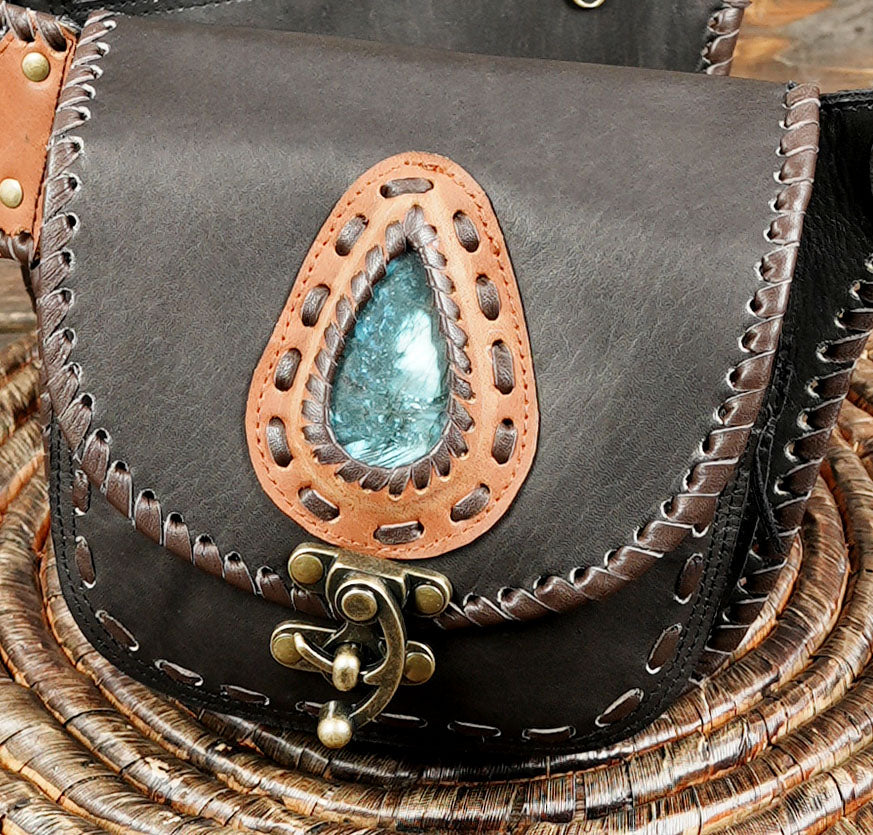 Boho-inspired leather waist pouch with dual compartments and stone accents