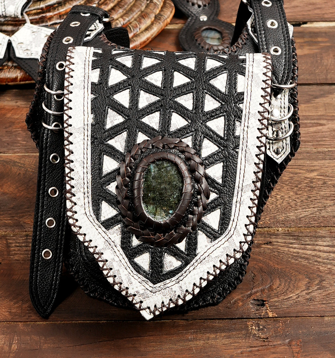 Close-up of geometric leather holster bag with gemstone centerpiece
