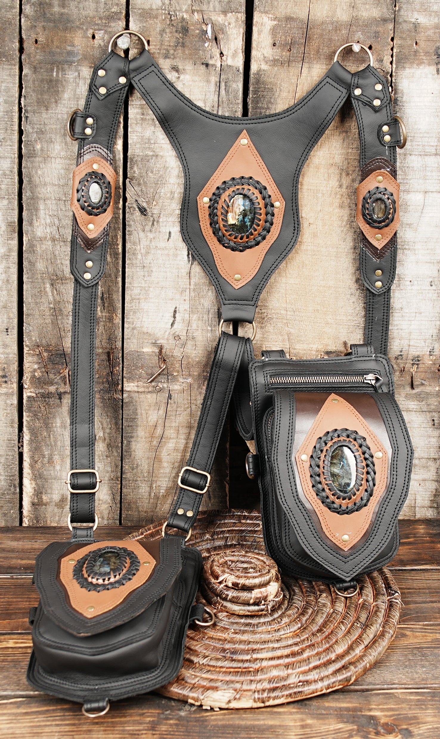 dual strap harness bag with decorative leather insets and metal rings
