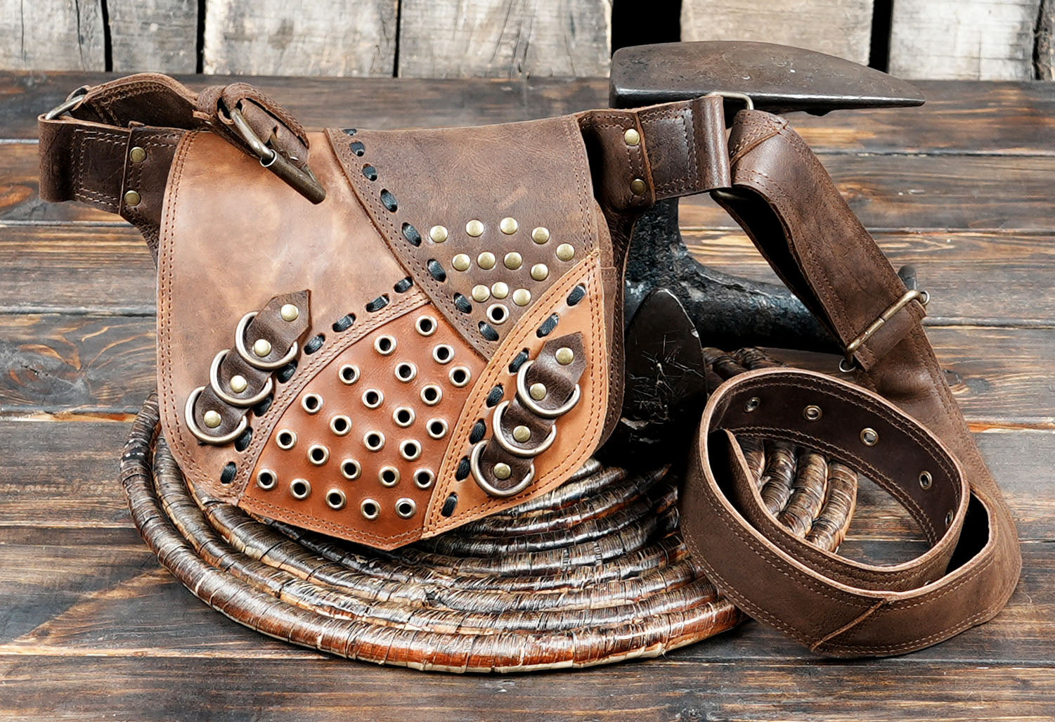Designed with studded rivets and multi-ring detailing, it adds a bold and rustic edge to any outfit.
