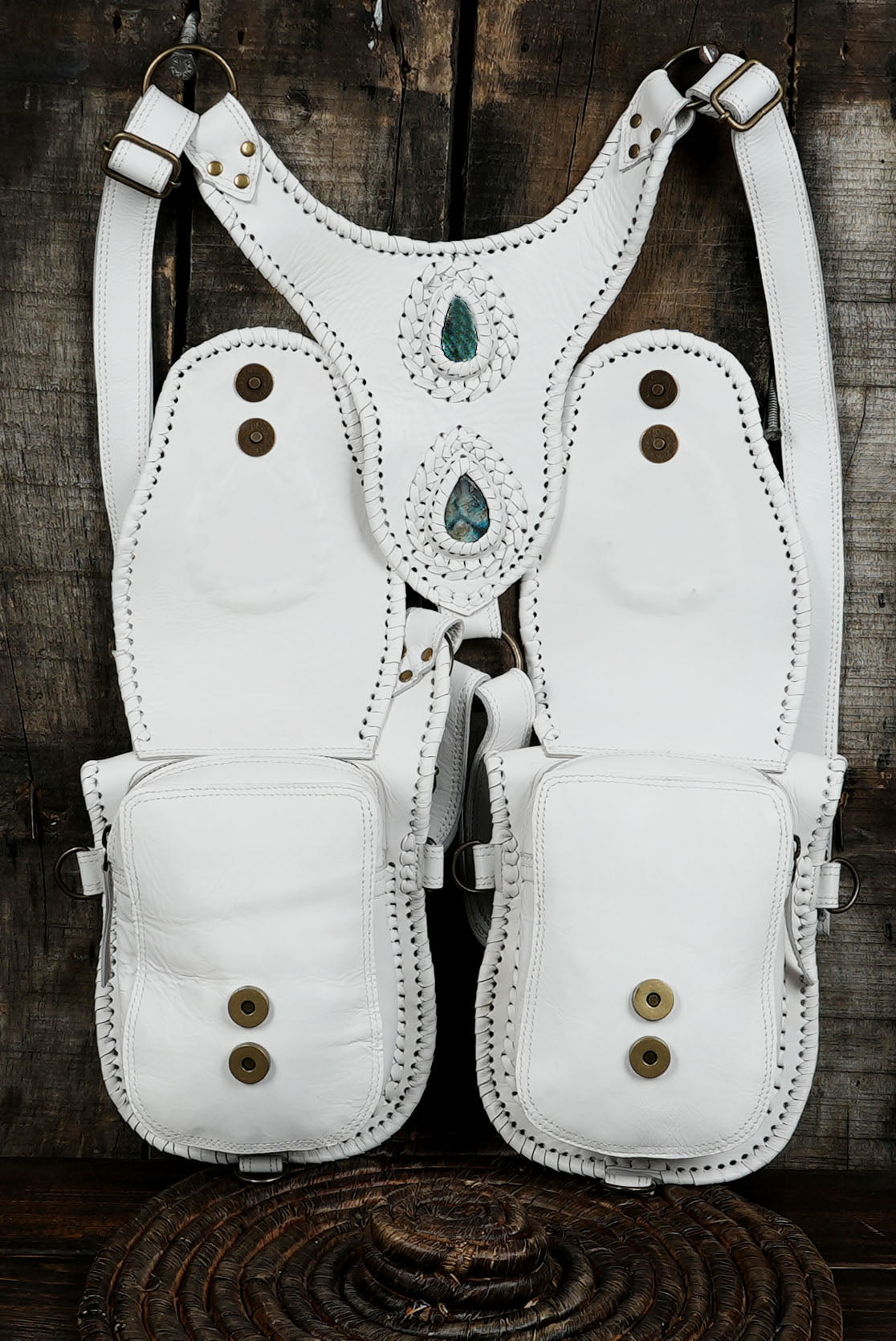Dual holster bag in white leather with braided edges and gemstone centerpiece.