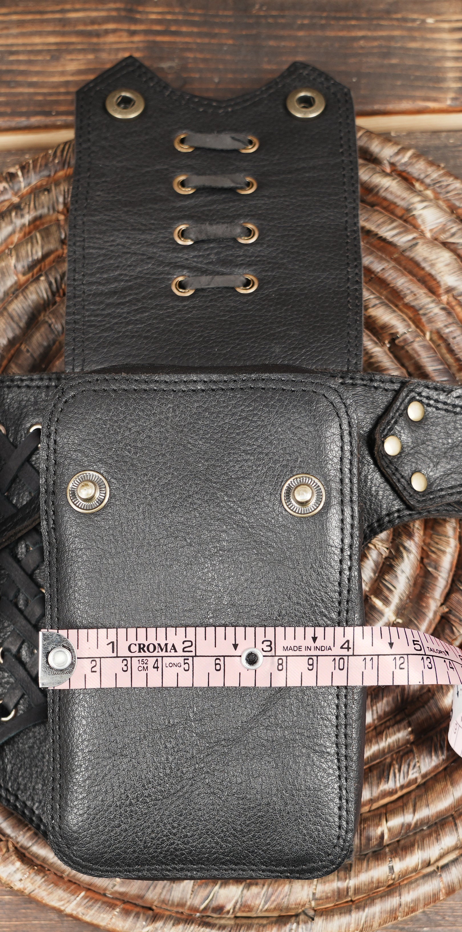 Adjustable leather waist belt with brass button closures