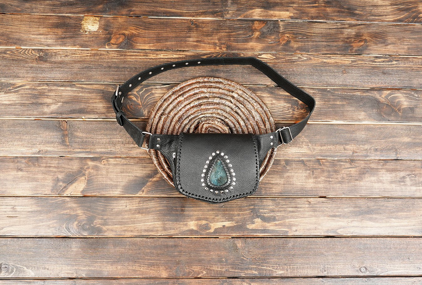Handmade black leather waist belt bag with blue gemstone centerpiece and silver studs.