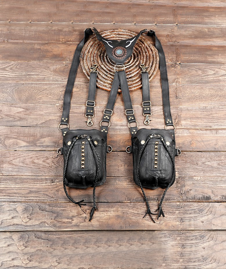 Handmade black leather double holster harness bag on wooden background