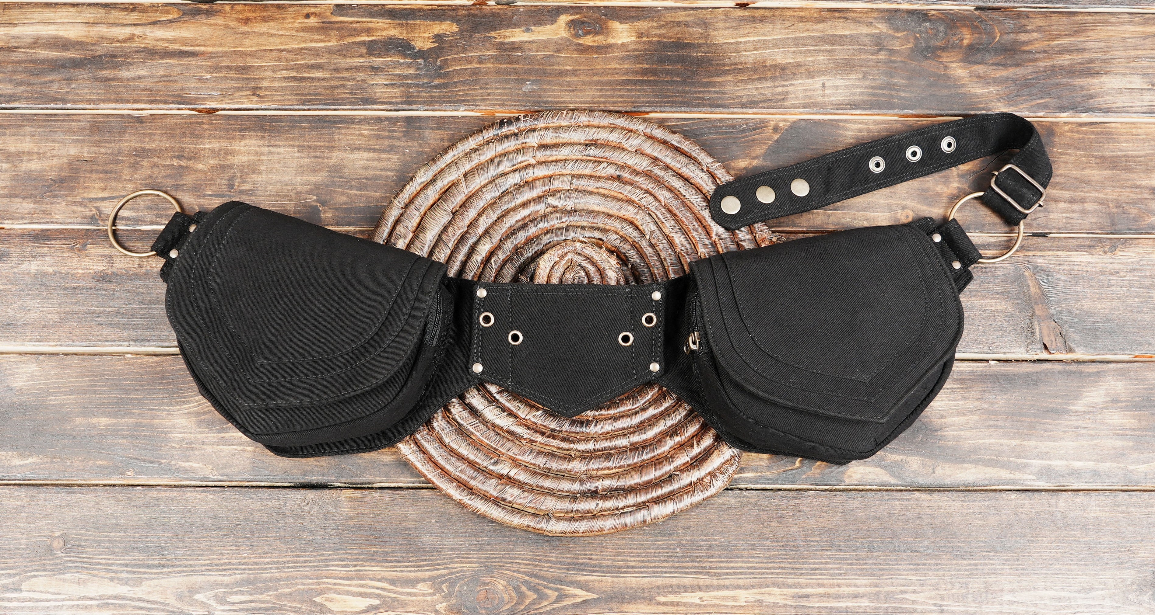 Black double pocket canvas belt bag on wooden background