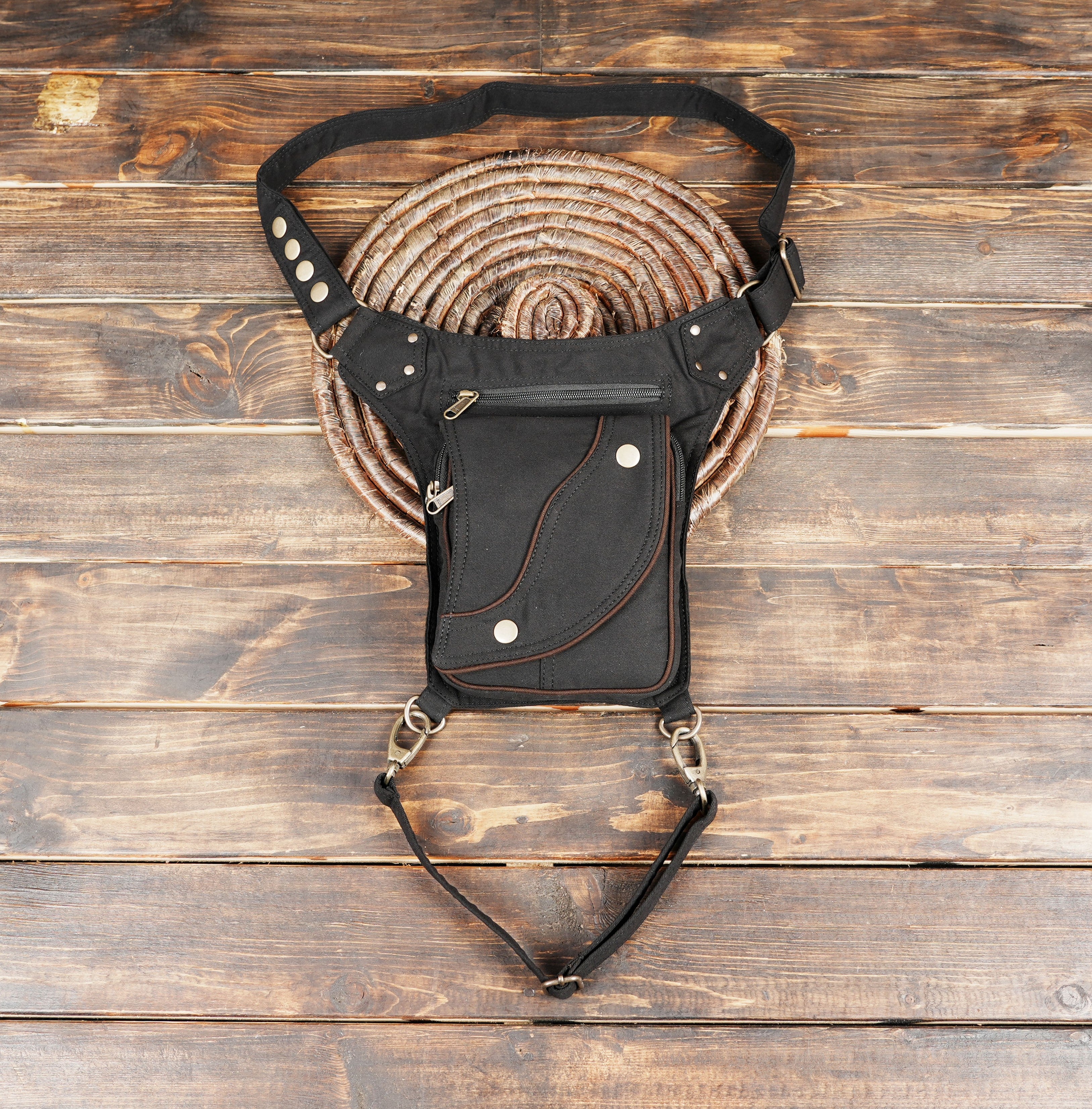 Black leather waist thigh belt bag with adjustable straps.