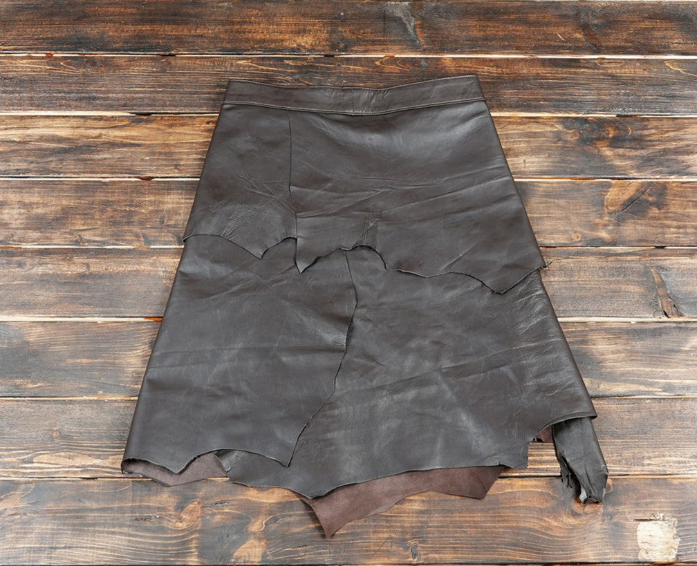 Unique raw-edge design with layered leather panels for a rugged, tribal-inspired look