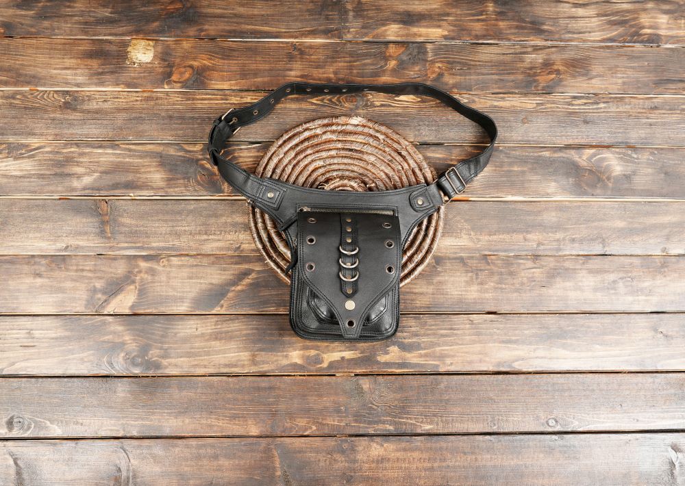 Black leather waist bag with rivets and metal ring design