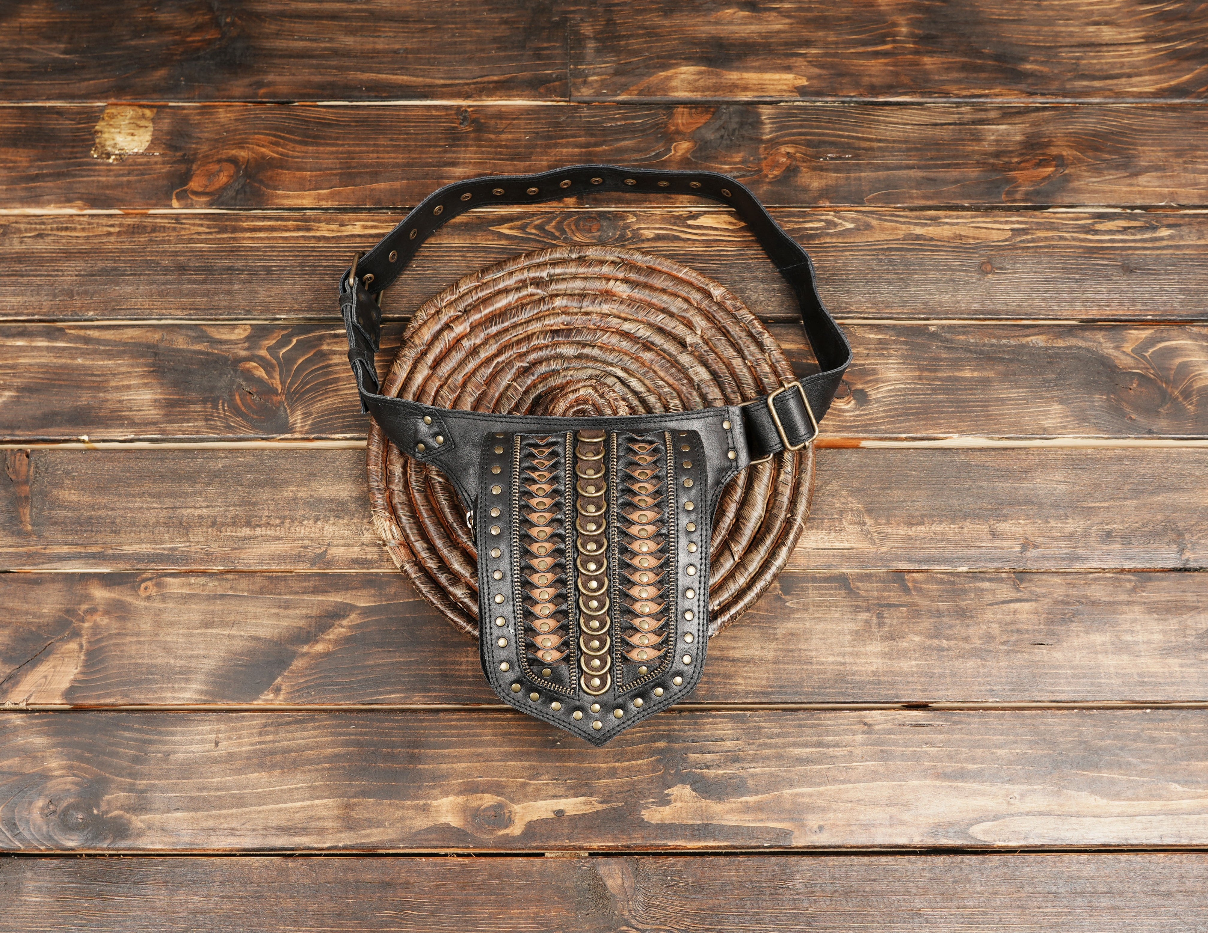 Back view of black leather hip bag with zipper pocket