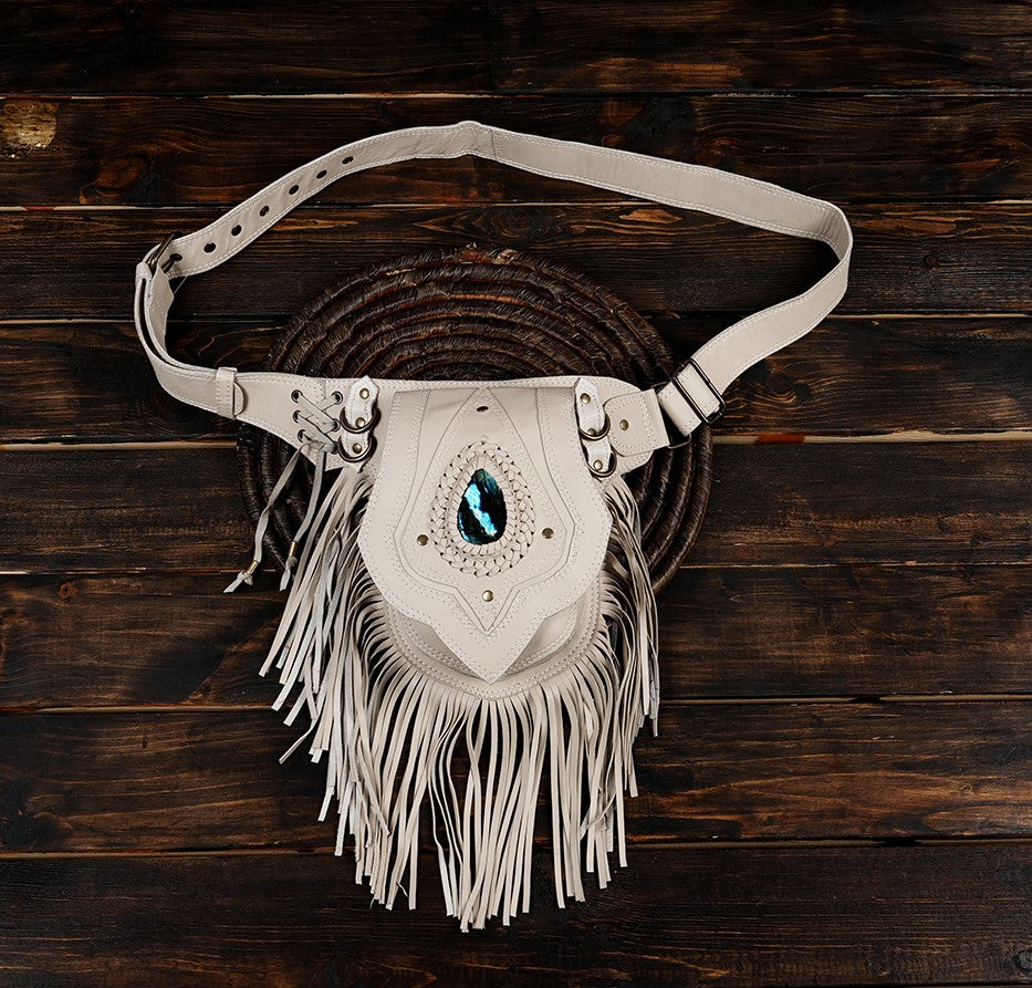 White leather waist belt bag with long fringe and blue gemstone
