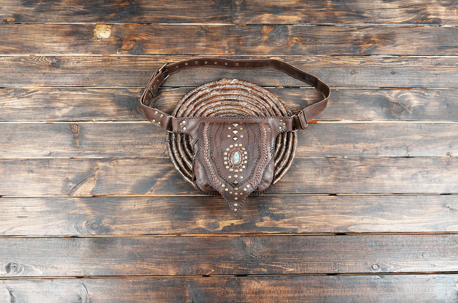 Black leather hip pouch with brass rivets and gemstone inlay