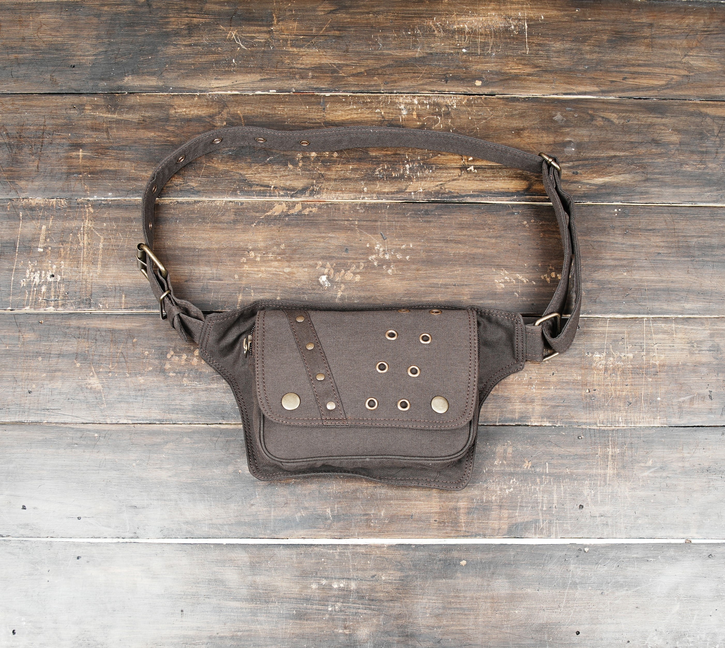 Brown canvas waist bag with brass rivets and adjustable belt
