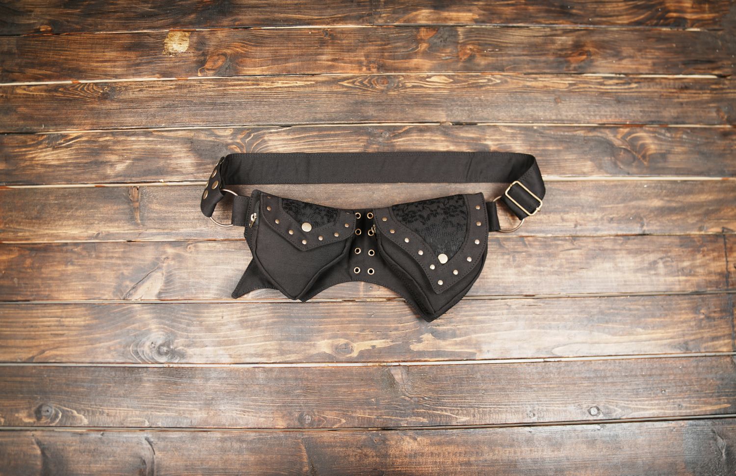 Black gothic utility belt with double pockets on wooden background