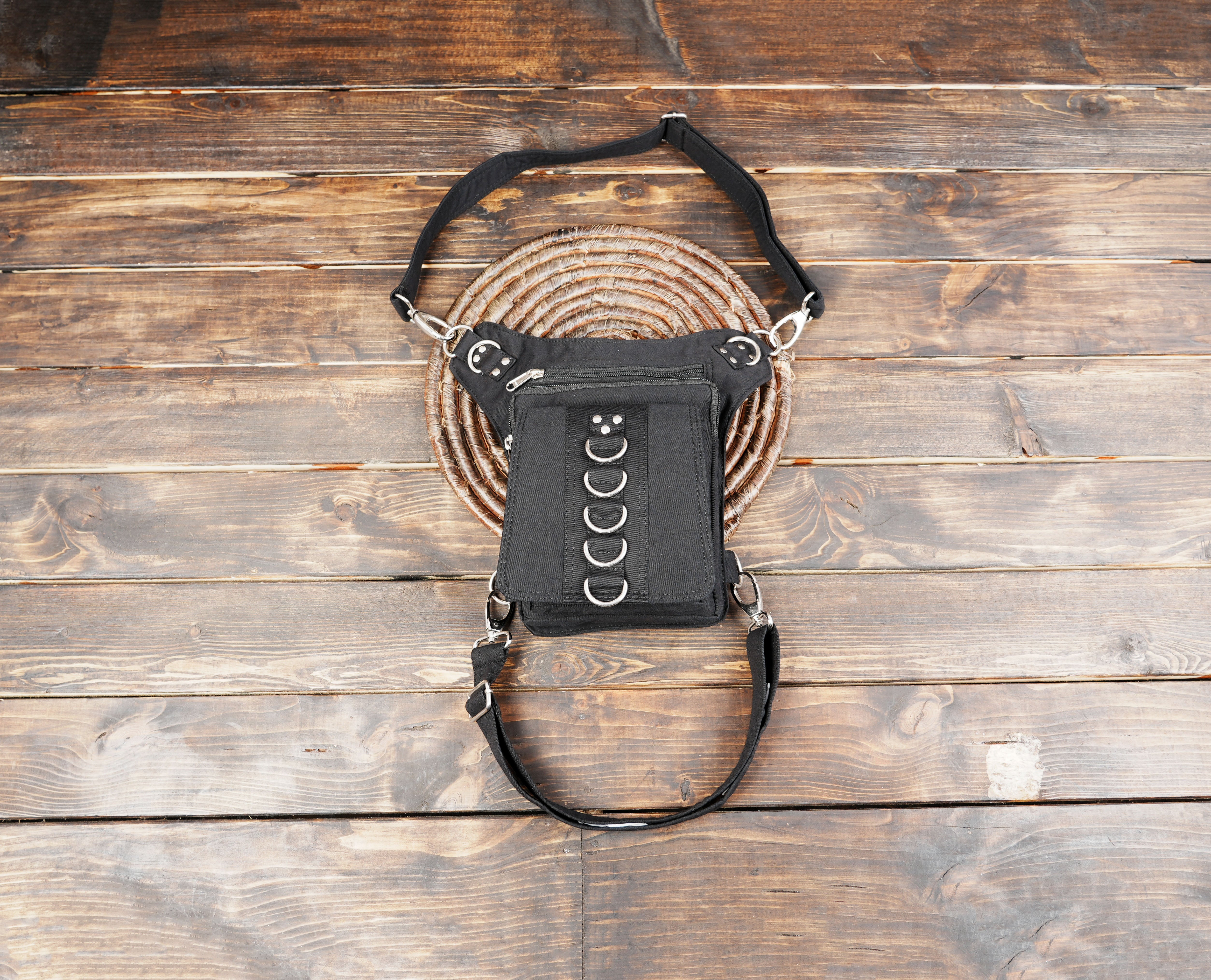Black cotton waist and thigh bag with metal ring accents on front panel