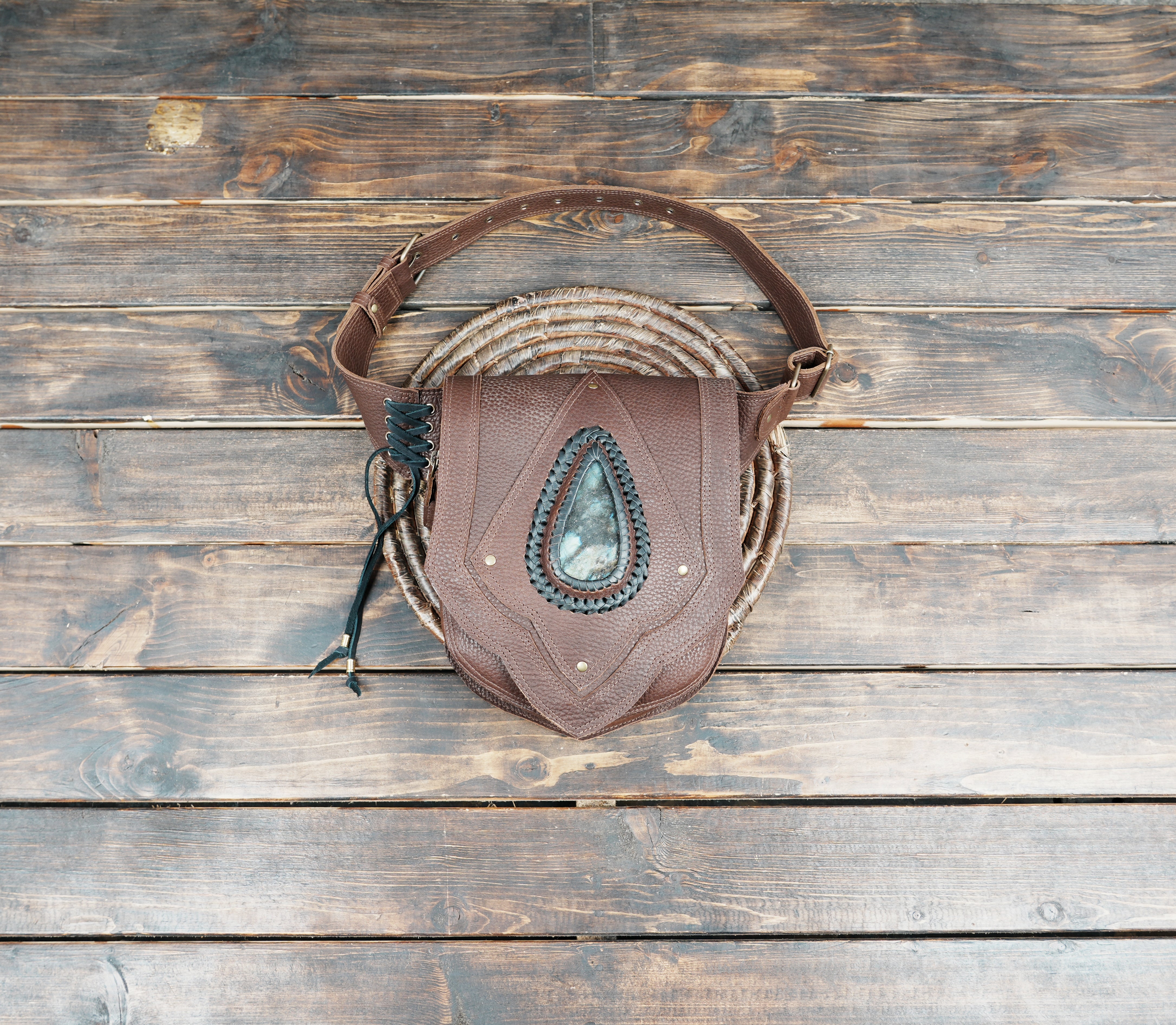 Brown leather waist belt bag with teardrop stone centerpiece and braided trim