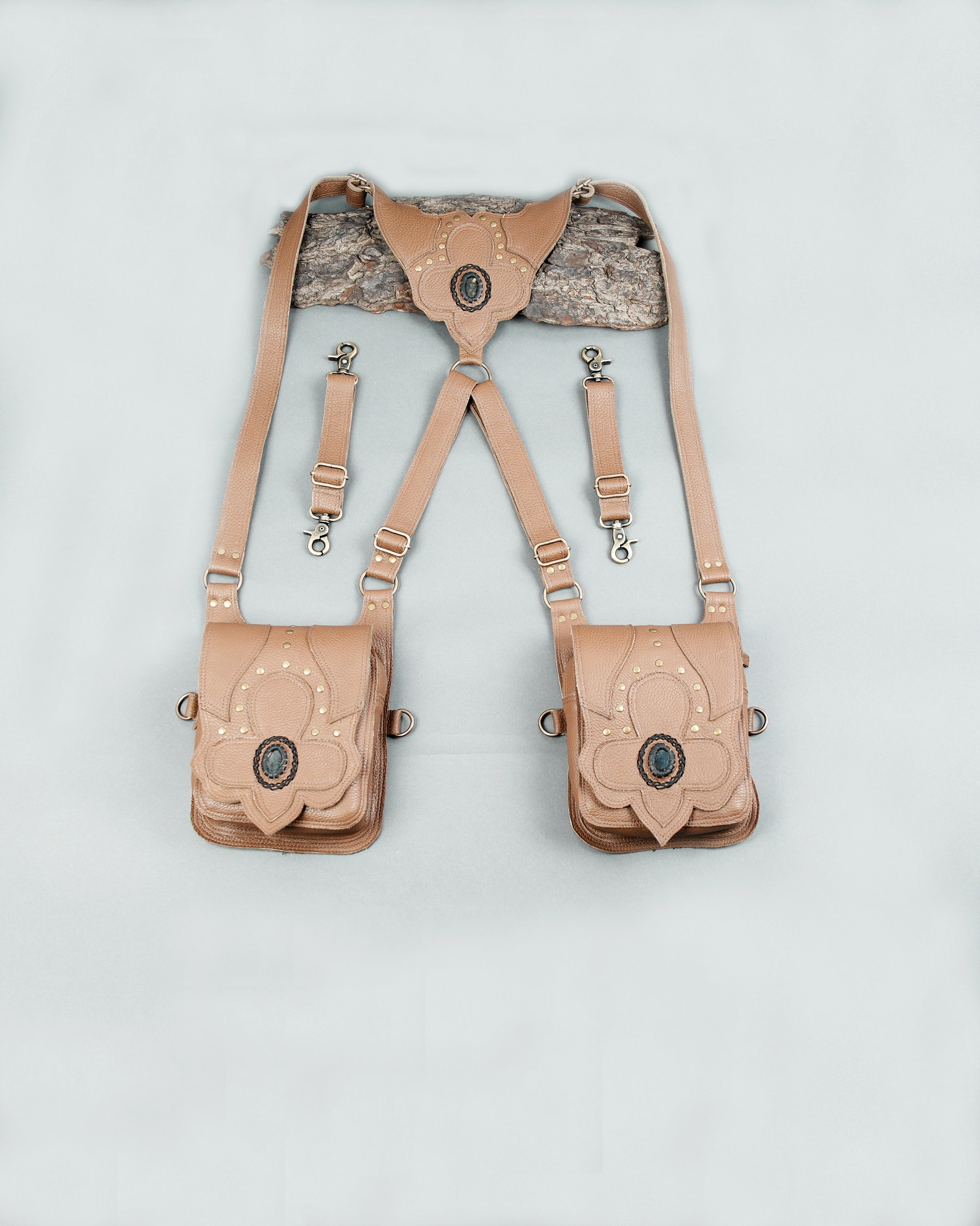 Brown leather festival bag with detailed stitching and gemstone