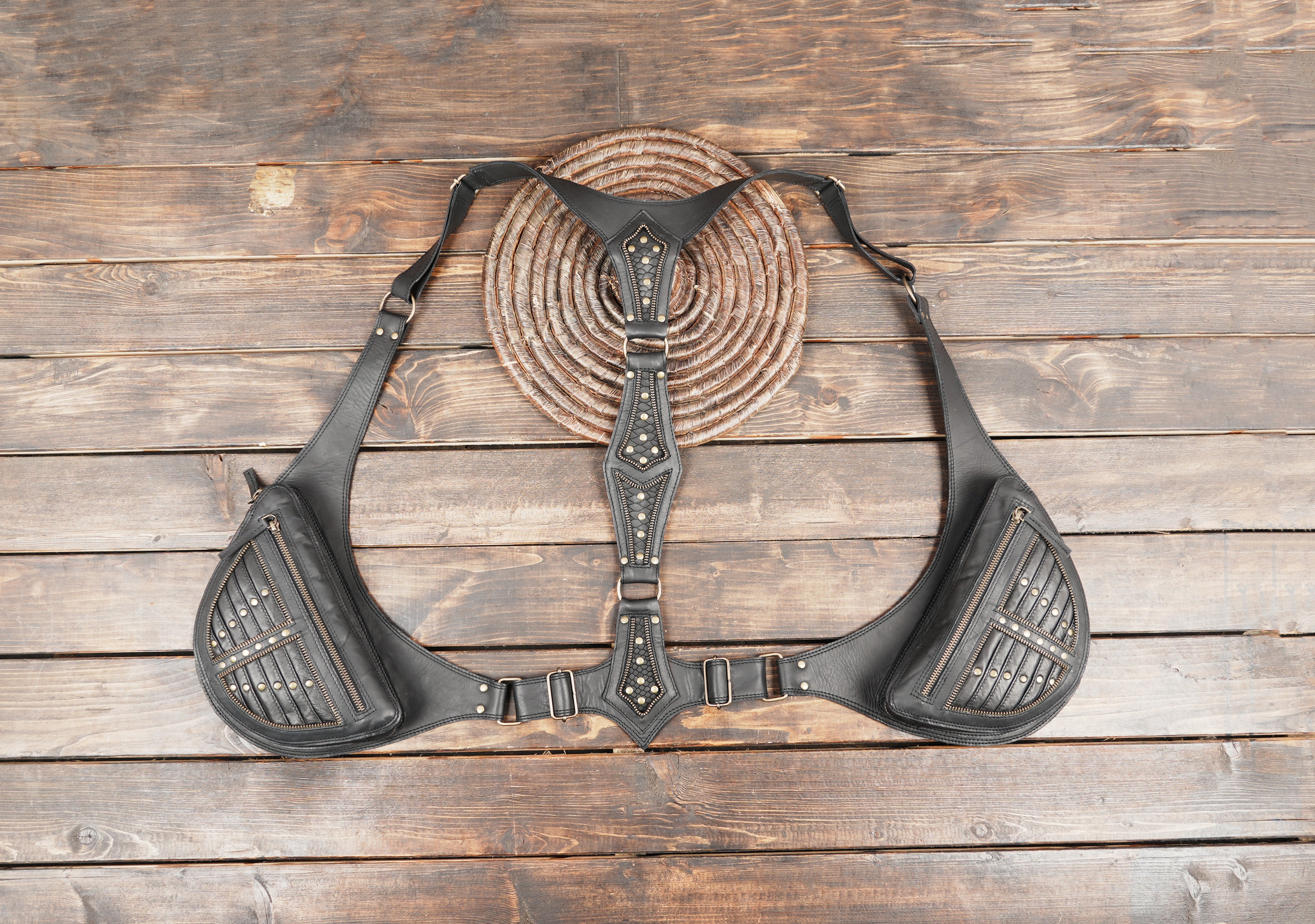 Black leather shoulder holster with dual zip pockets and adjustable straps