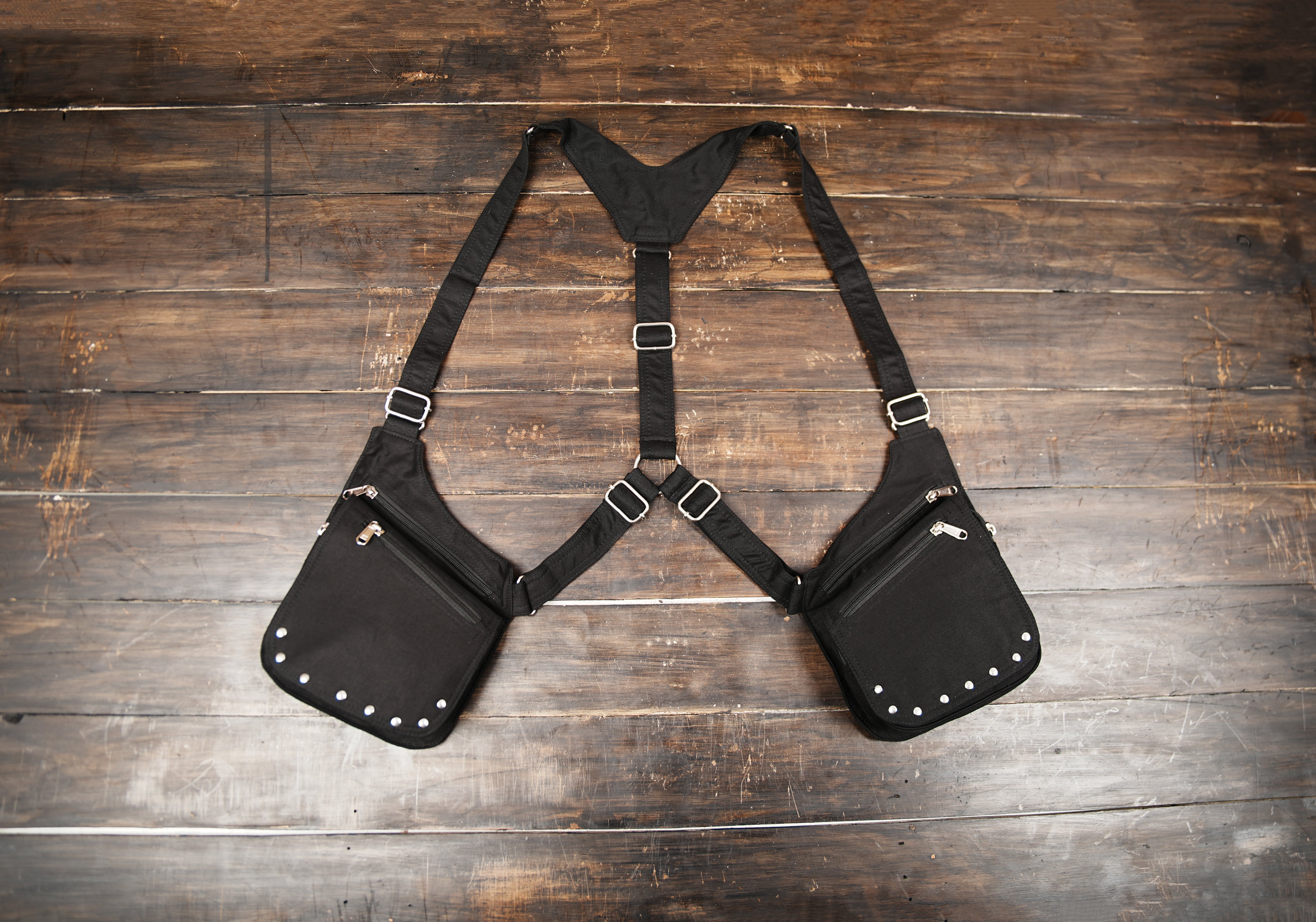 Black cotton holster bag with adjustable straps and dual zip pockets