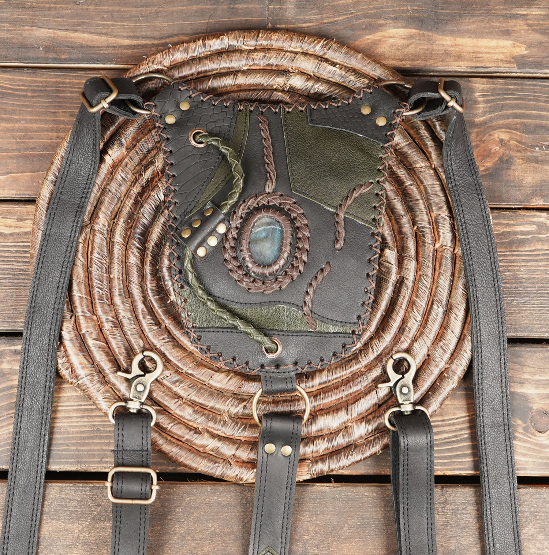 Gothic warrior-style holster with green and dark brown leather patchwork design.