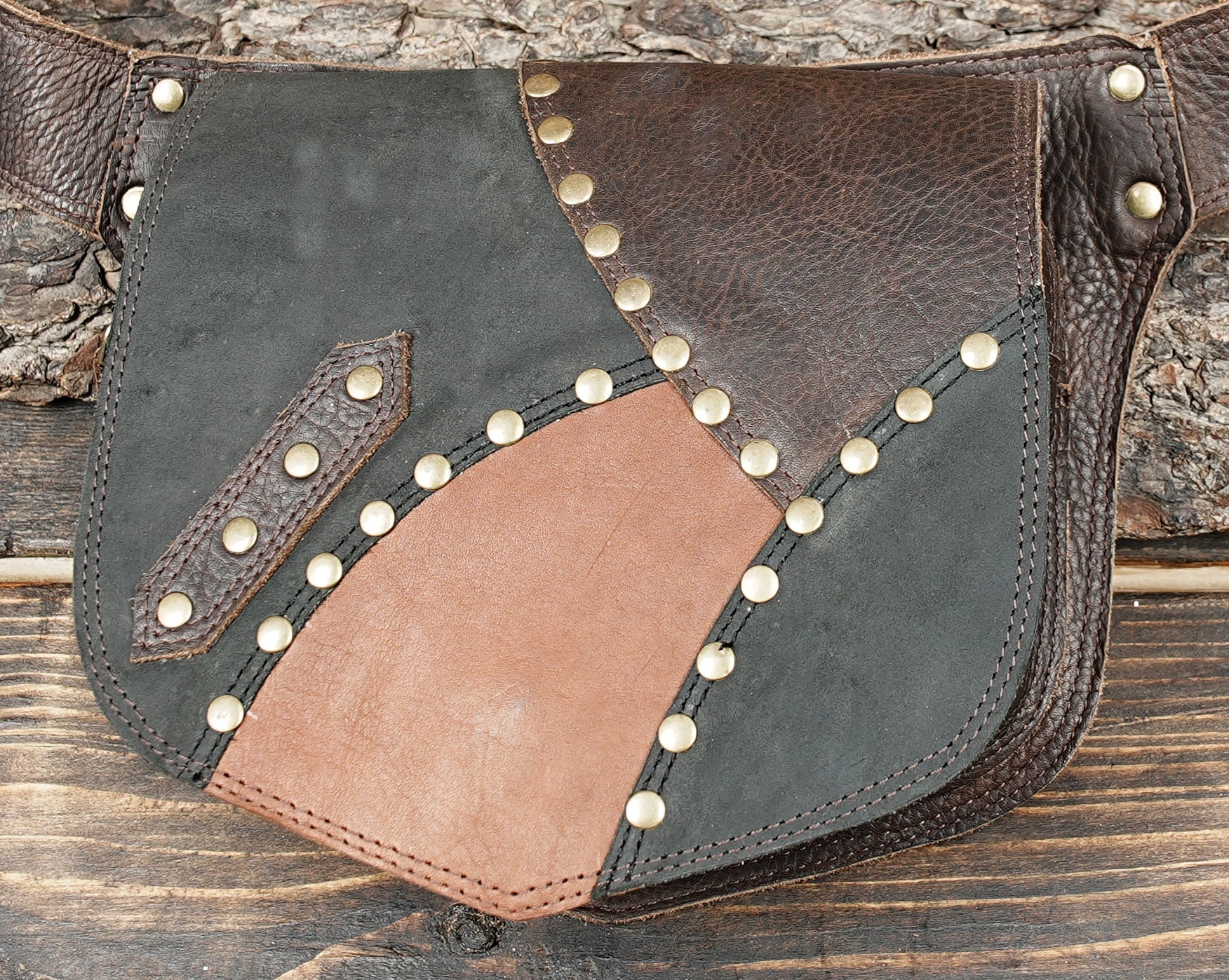 Patchwork leather hip bag featuring brown and black panels