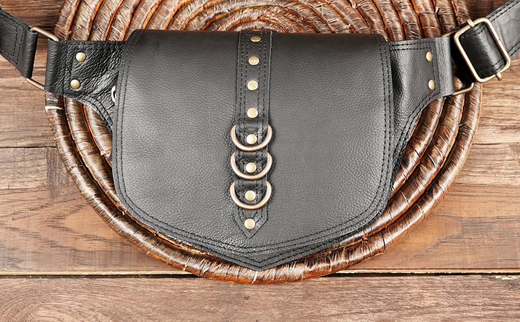 Artisan-crafted waist holster bag in black leather with adjustable belt and secure buckle.