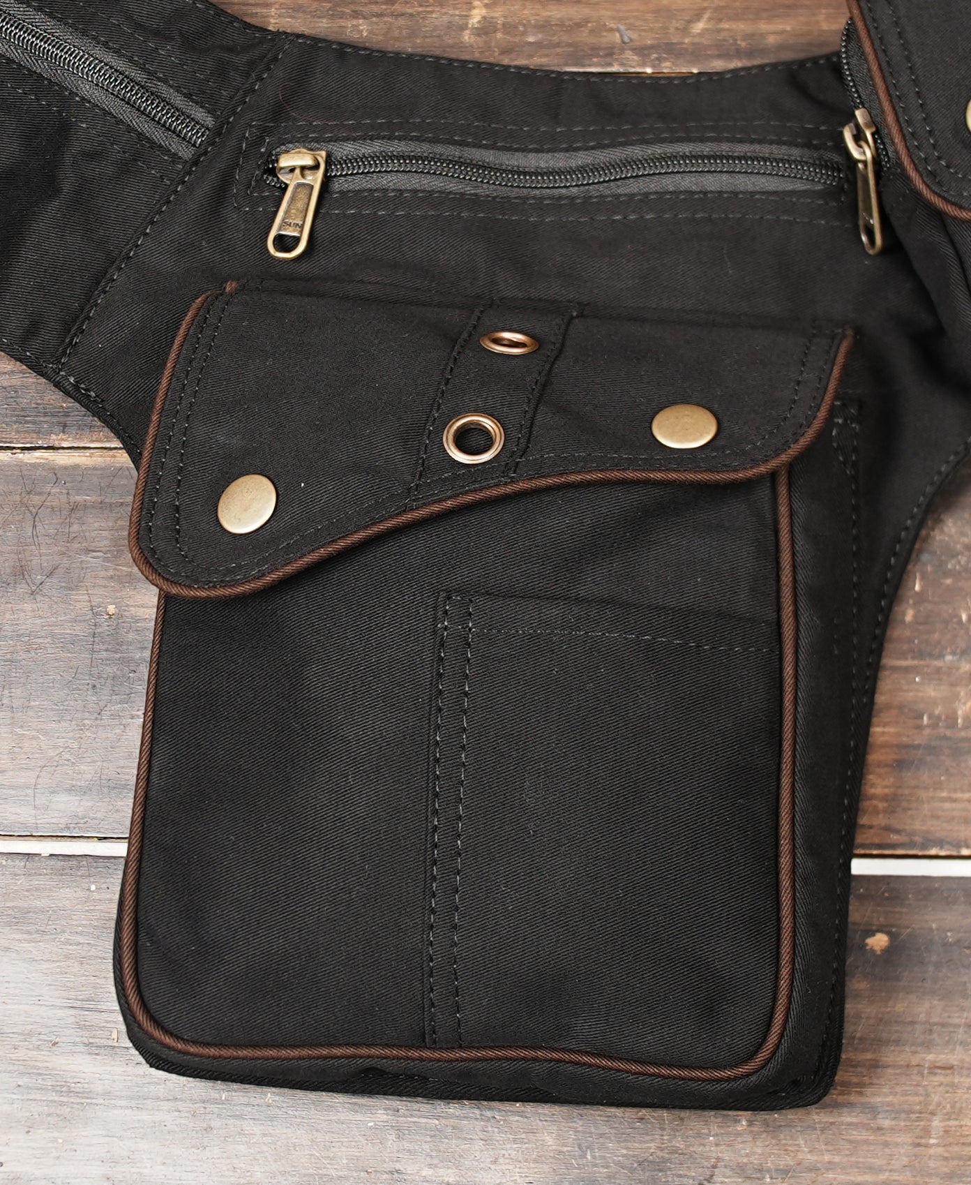 Patchwork leather hip bag featuring brown and black panels