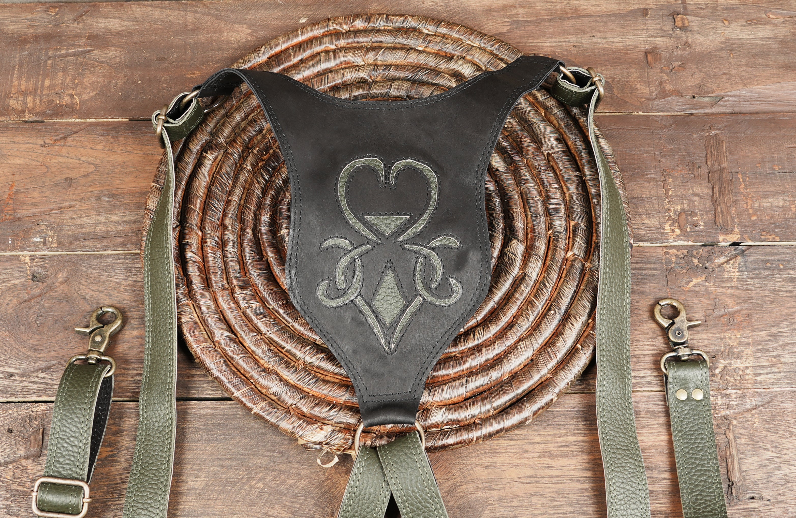 Handmade leather shoulder holster bag featuring double pouches and braided detailing.