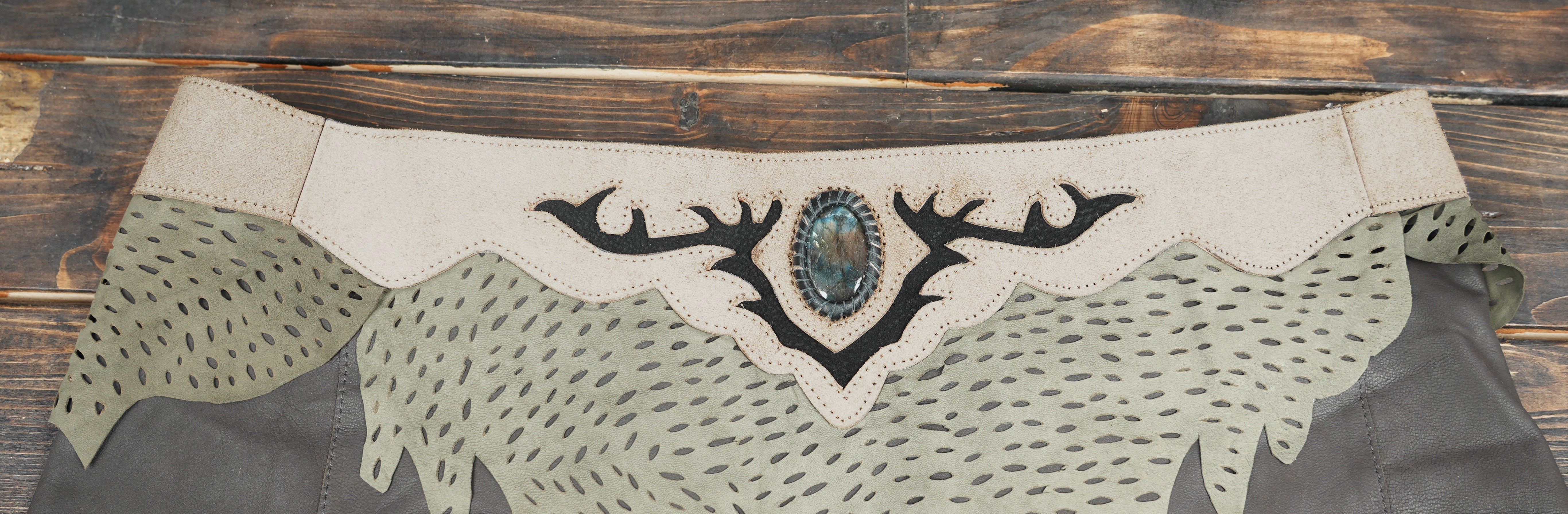 Women’s leather skirt with green foliage detailing