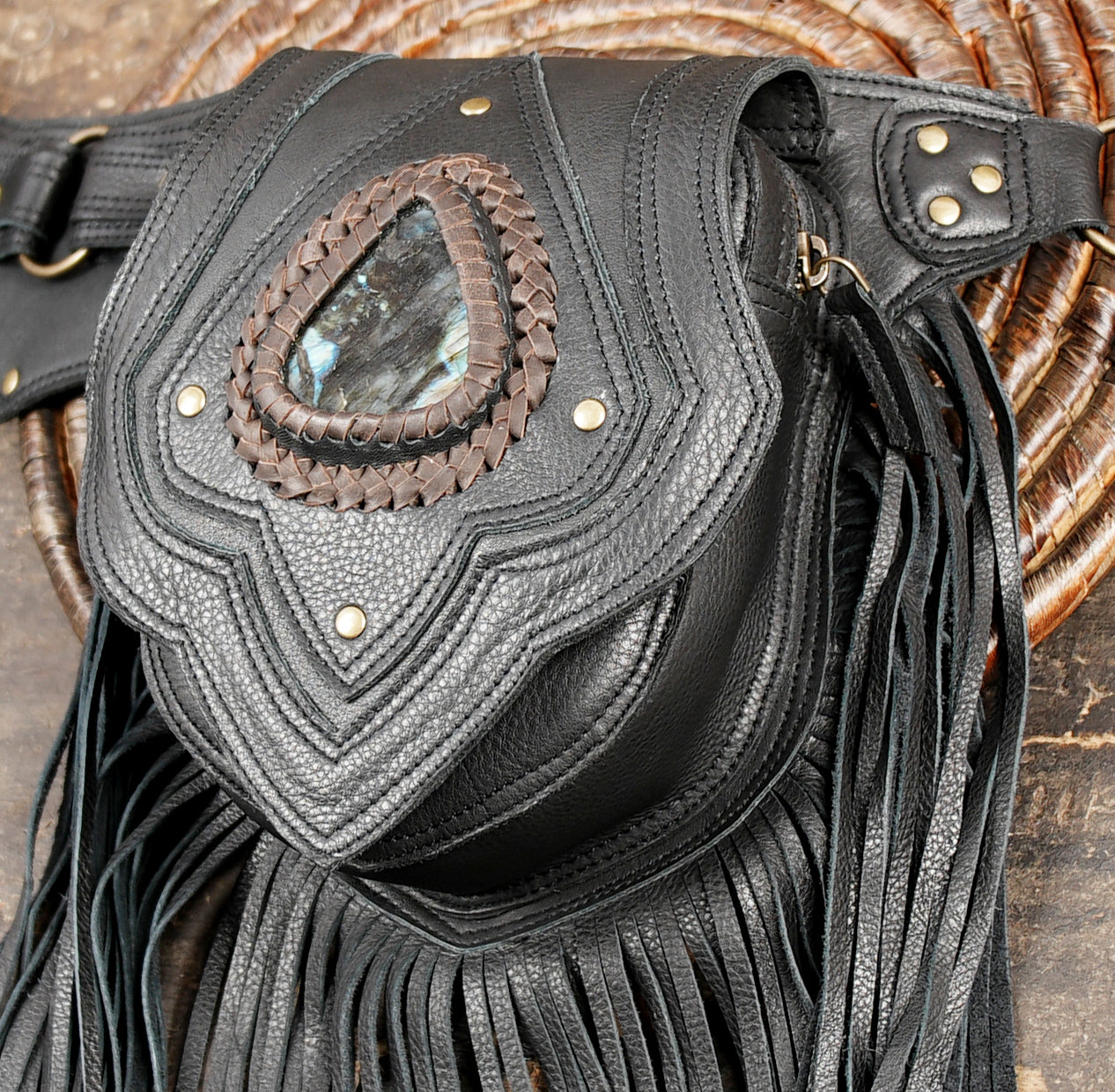 black leather hip bag with gemstone and fringe design