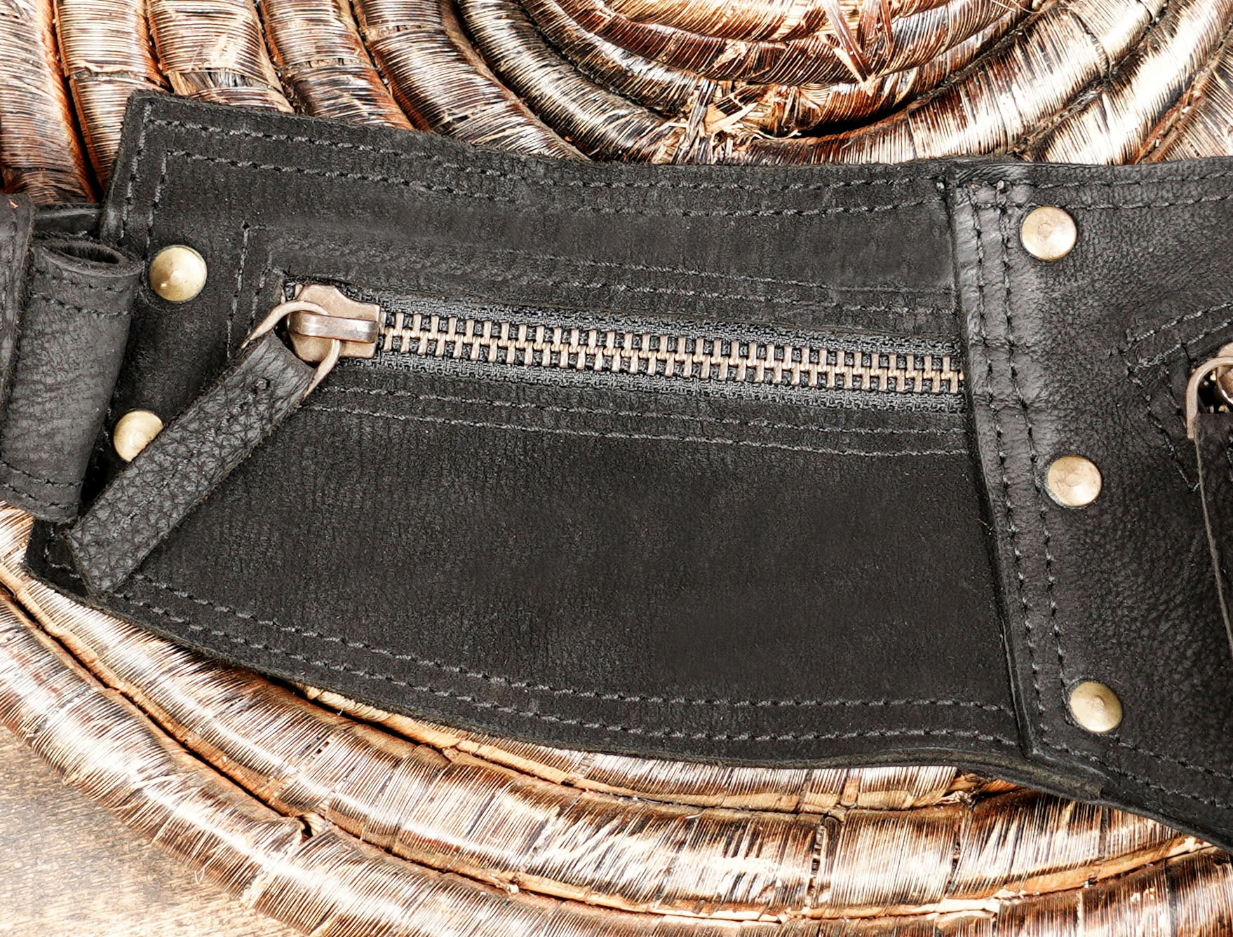 Small pocket detail of black fringe cotton waist bag