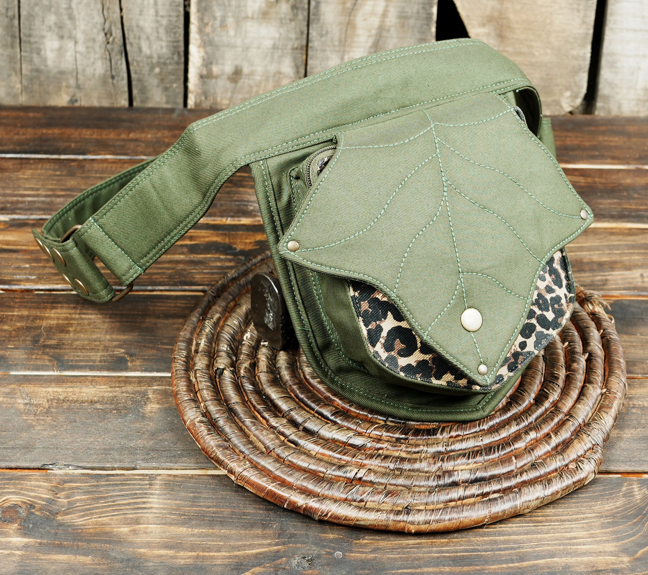 Leaf-shaped hip belt bag worn on men’s waist with adjustable strap
