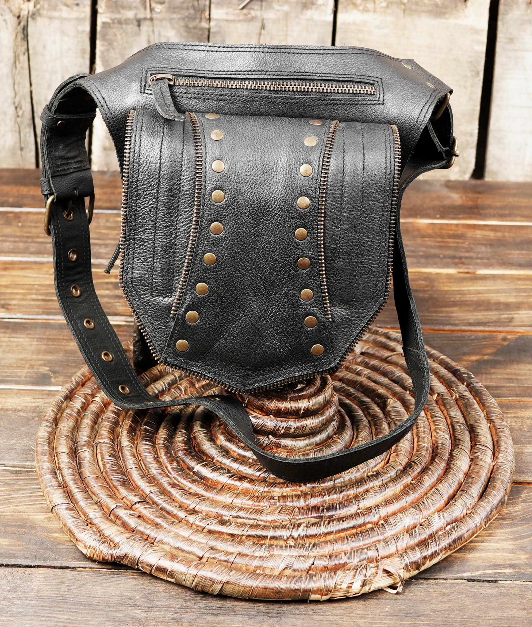 Steampunk-inspired black leather fanny pack with rivets