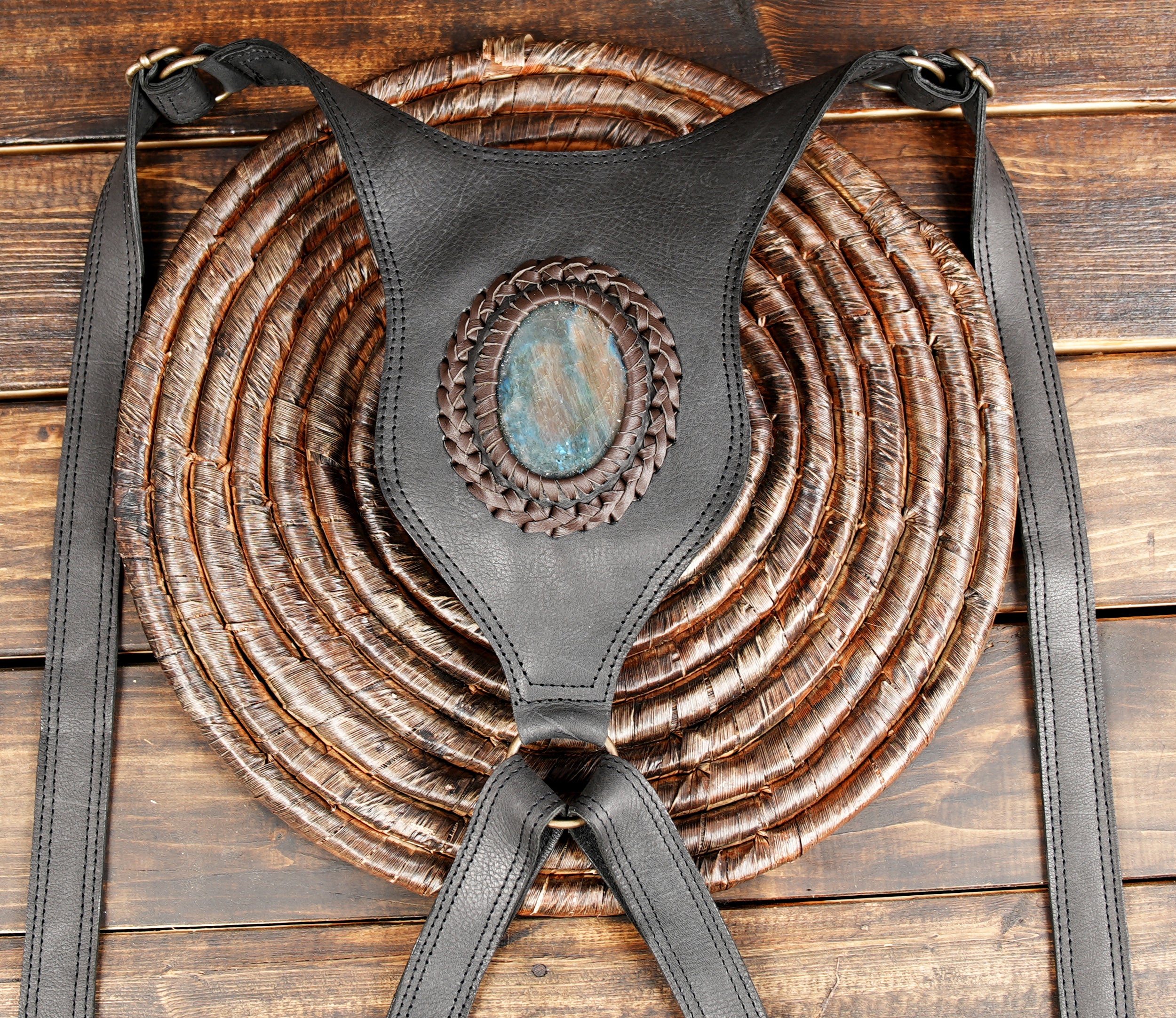 Boho-chic leather harness bag with gemstone accent.