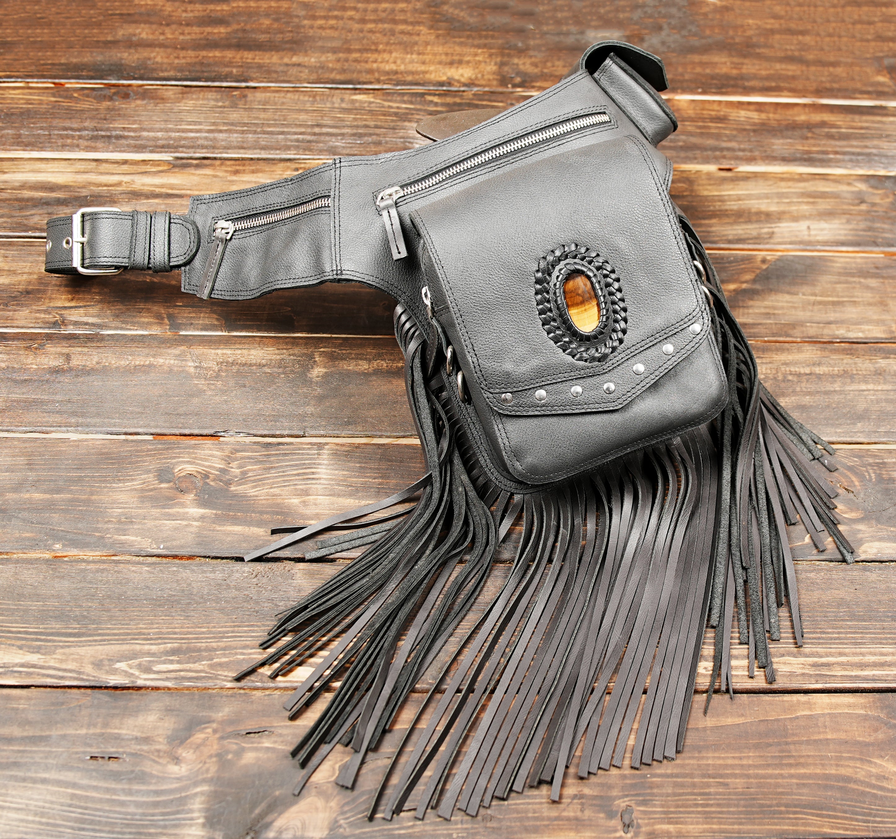 Artisan leather fringe bag for waist or hips with secure pockets.