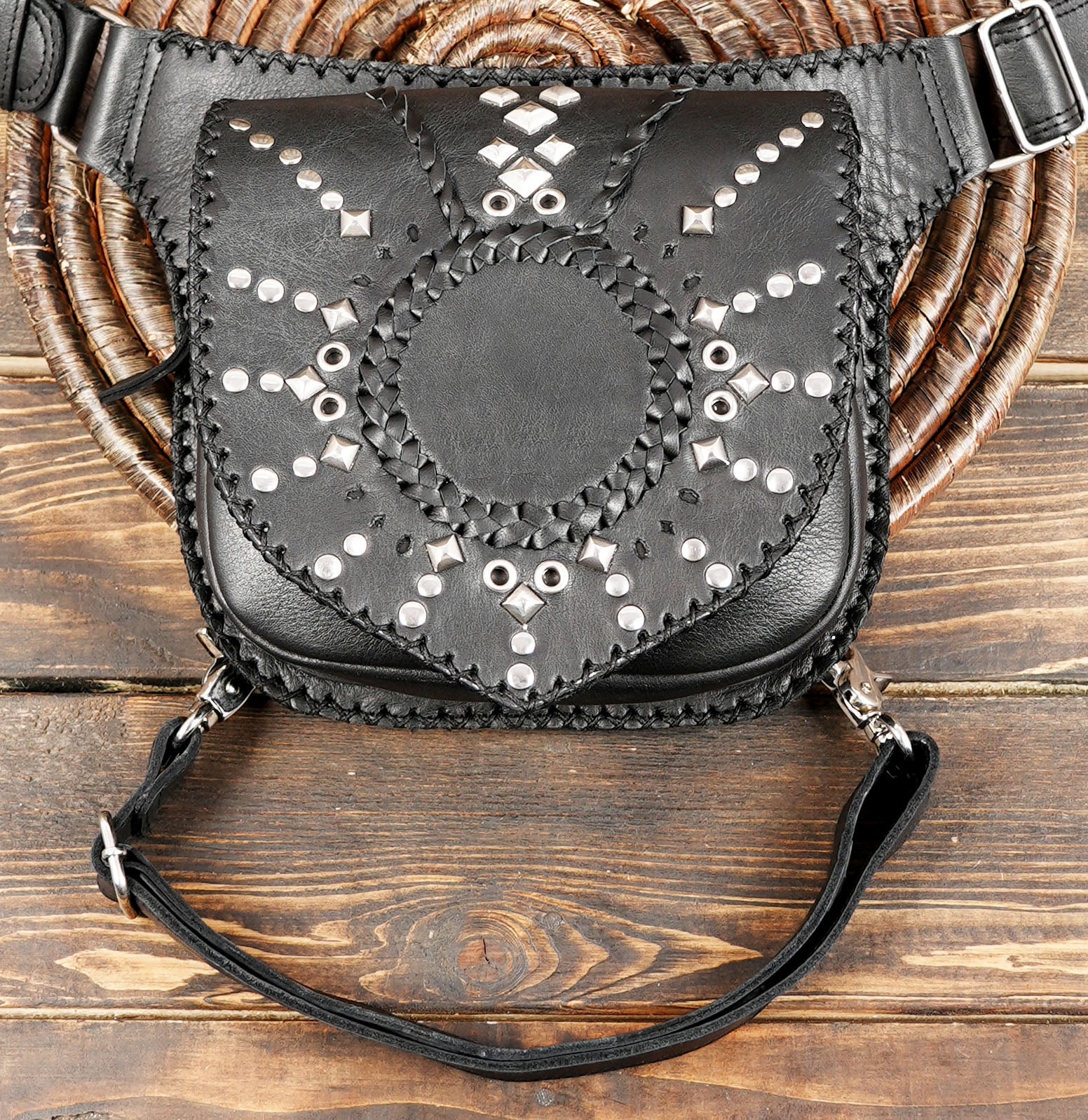 Boho western black leather hip pouch on rustic wood surface
