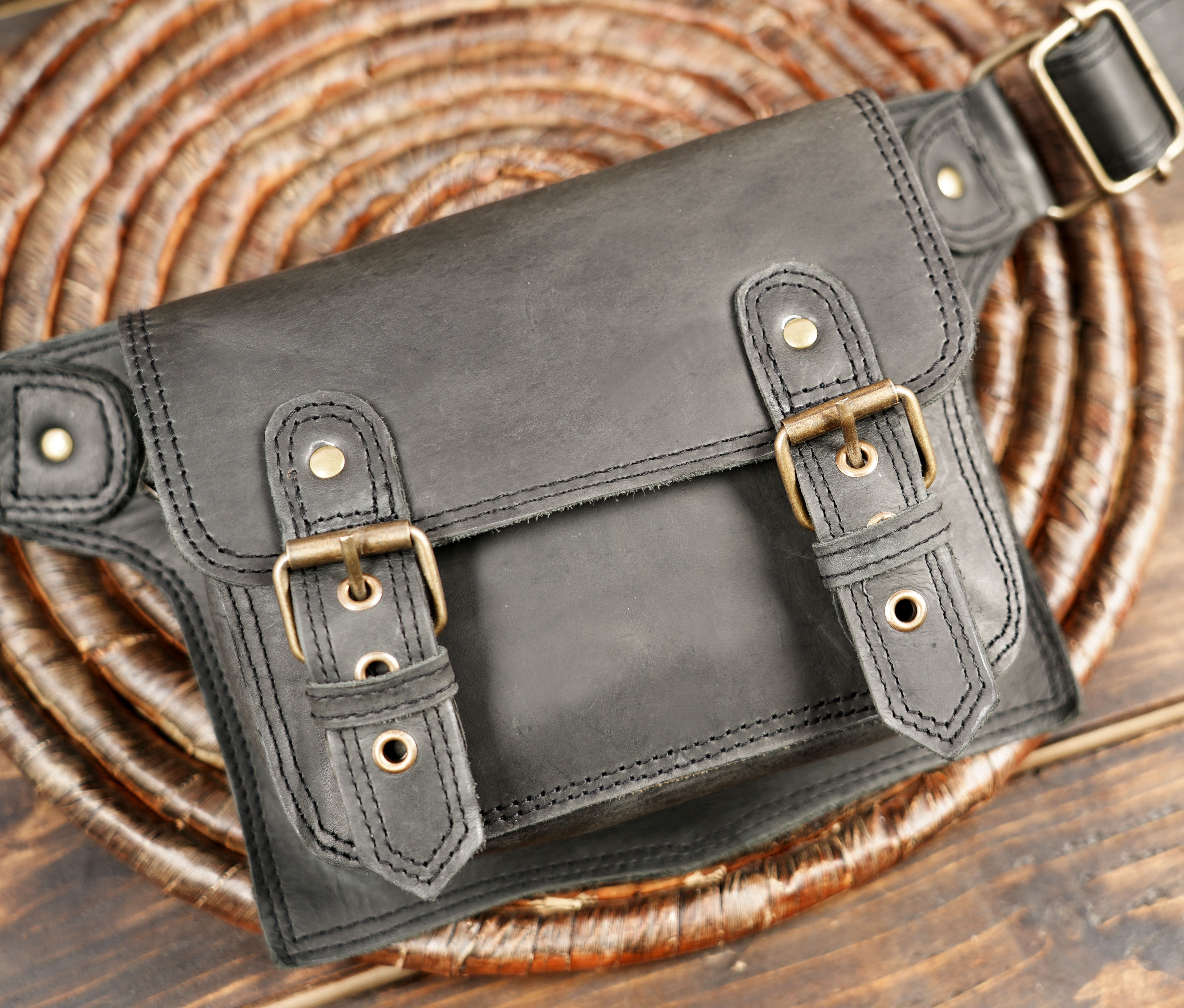 Unisex black leather waist pouch styled for everyday use