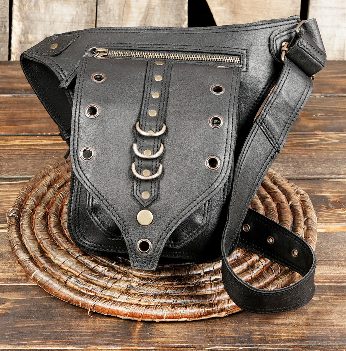 Black leather belt bag with zipper pocket and rivet details
