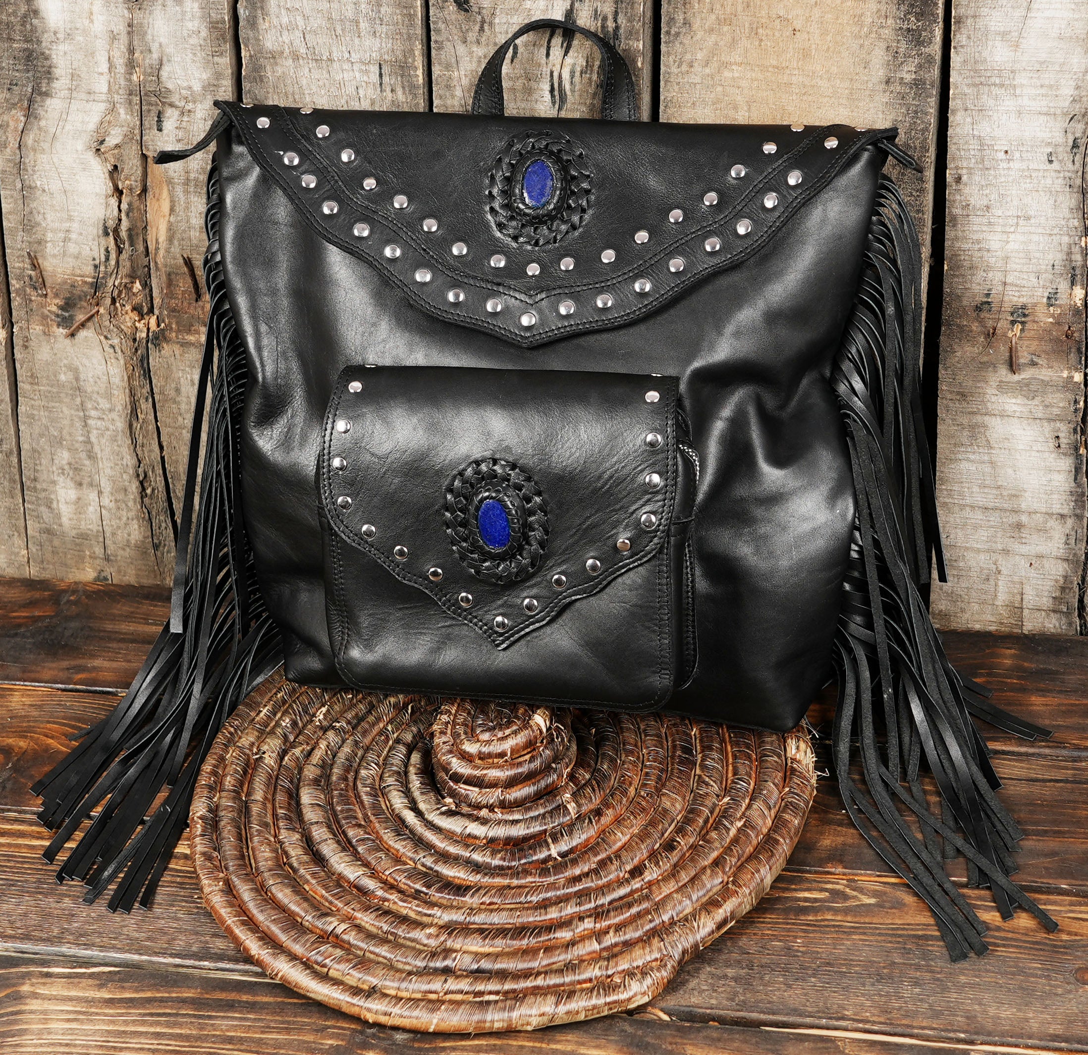 Front view of black leather boho backpack with gemstone design
