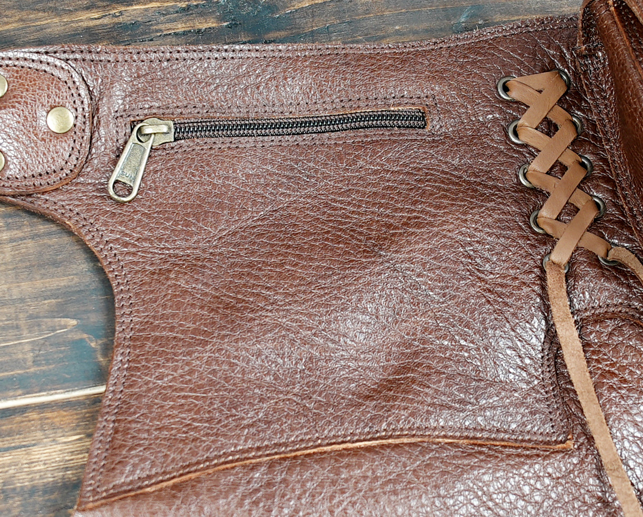 Unique boho leather skirt with utility pouches and rustic texture, handmade for festivals.