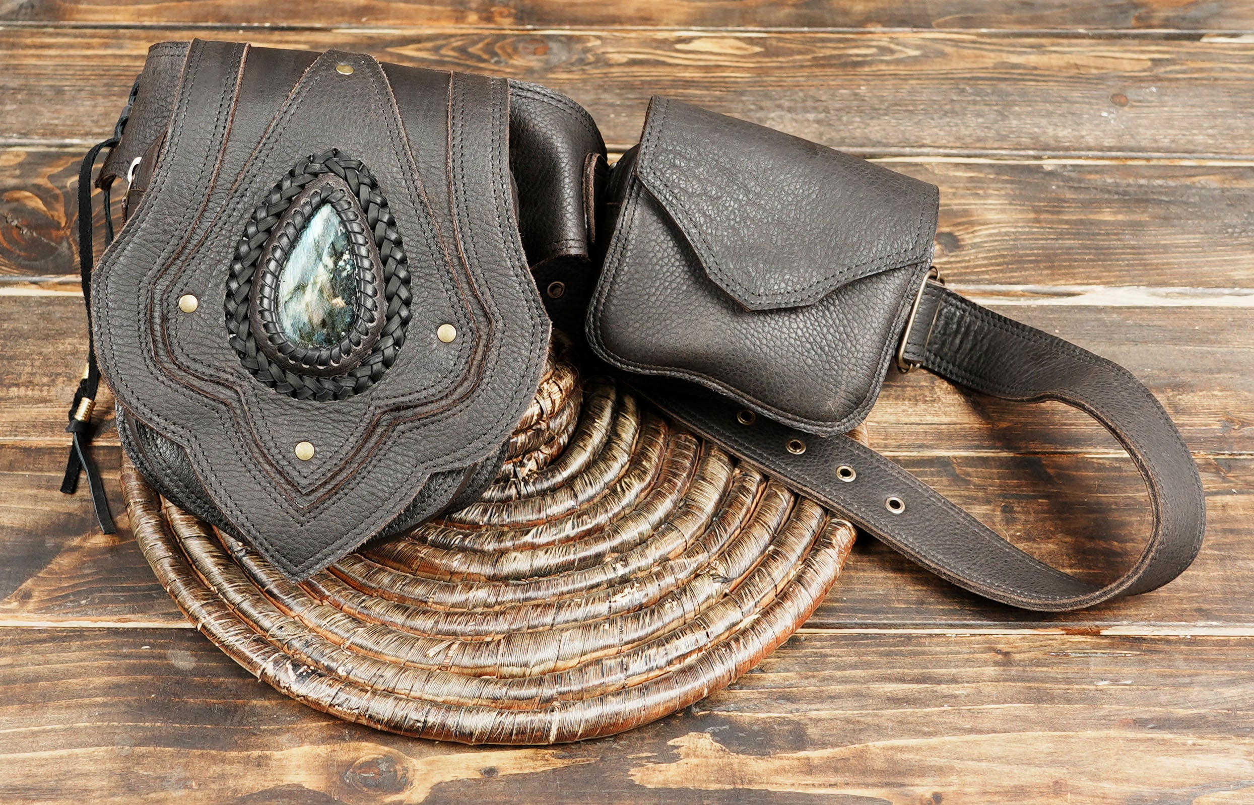 close-up of textured leather holster bag with gemstone inlay and woven trim